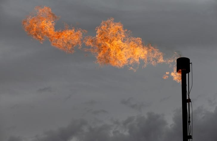 A flare burns off excess gas from a gas plant in the Permian Basin in Loving County