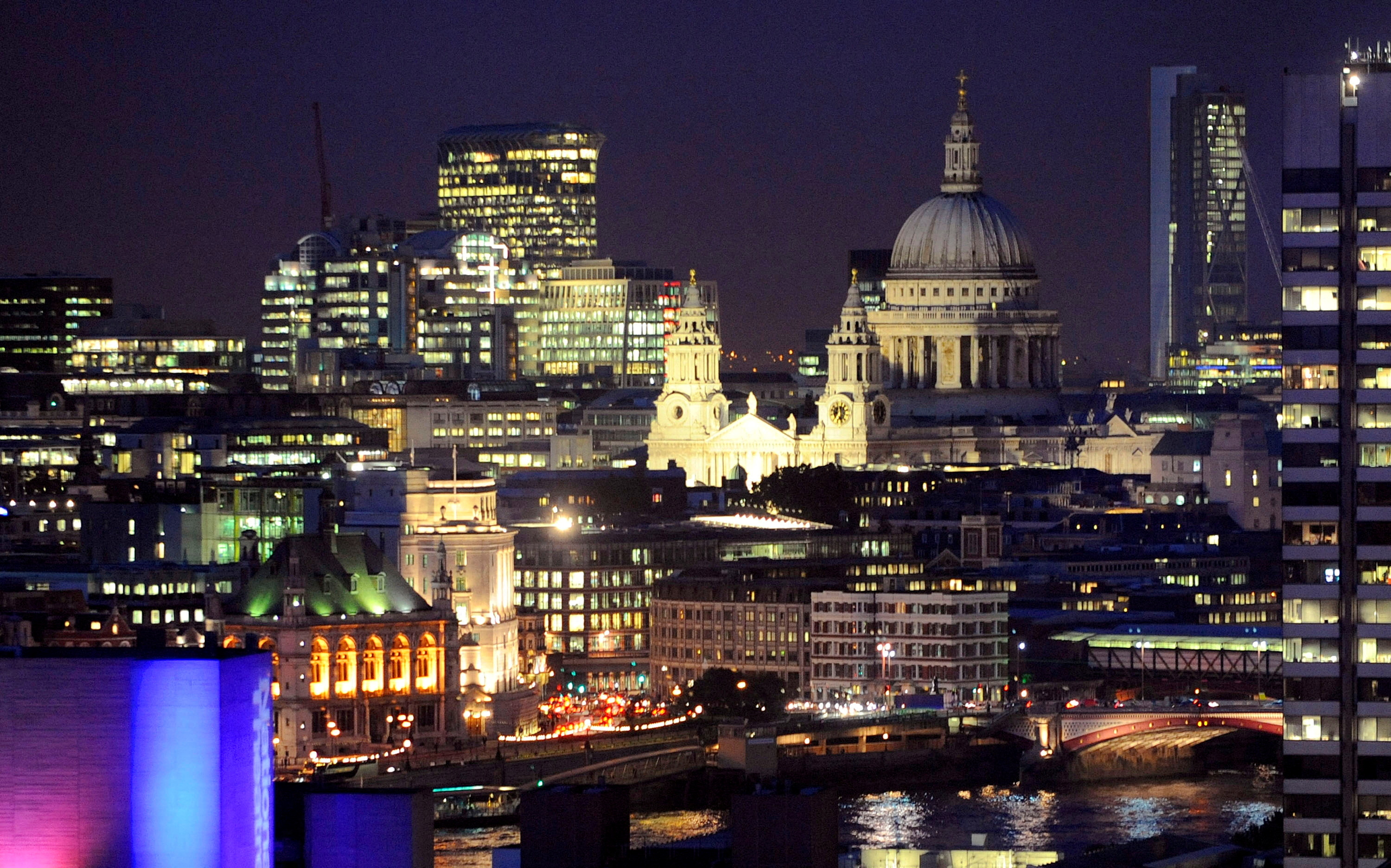 St Paul's Cathedral and areas of the financial district of the City of London are seen at dusk