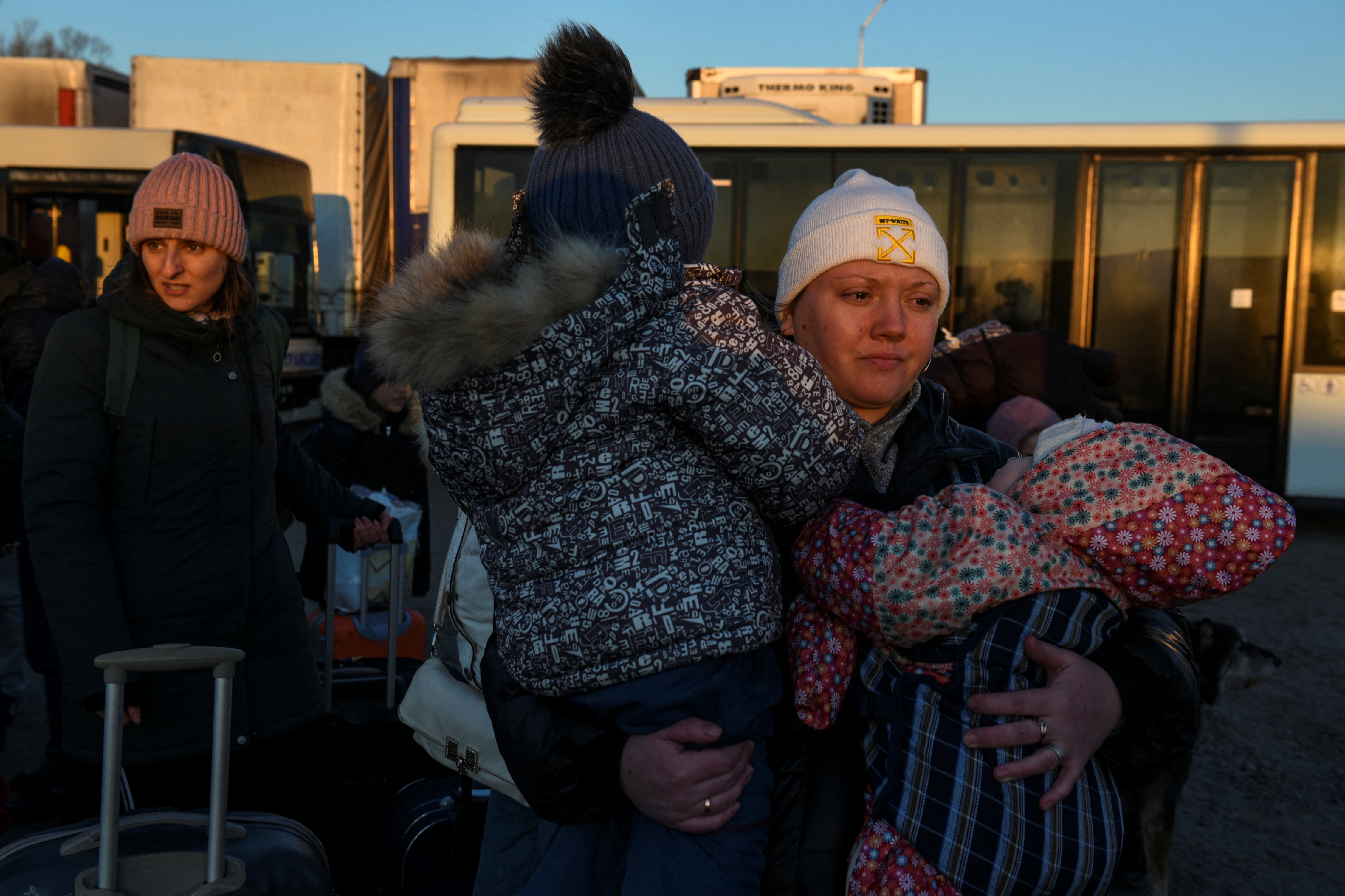 Civilians fleeing Russia’s invasion of Ukraine, arrive on a bus in Orlivka