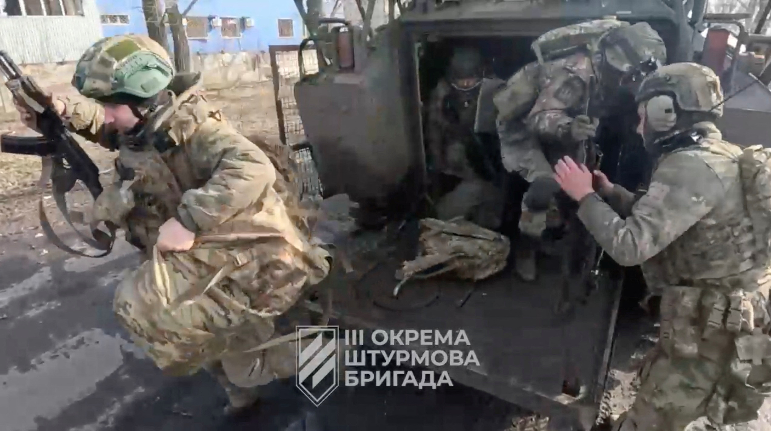 Ukrainian soldiers get out of a military vehicle in a location given as Avdiivka, Donetsk Region