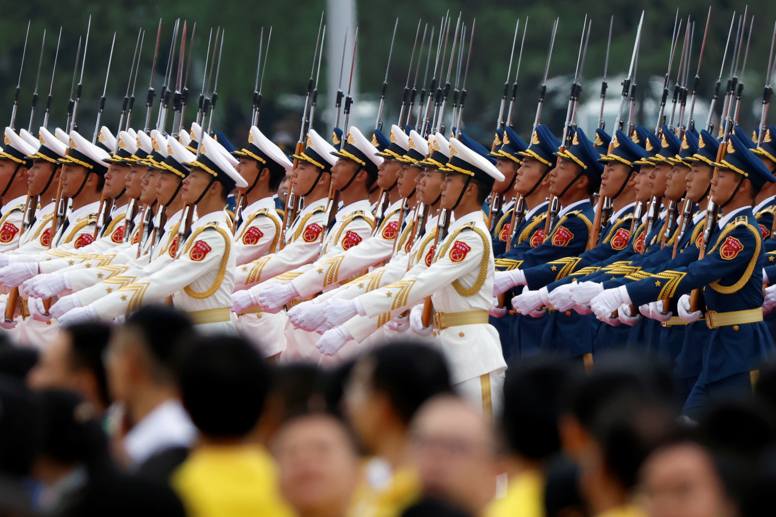 Members of the honour guard march past participants at the event marking the 100th founding anniversary of the Communist Party of China, on Tiananmen Square in Beijing, China July 1, 2021. REUTERS/Carlos Garcia Rawlins