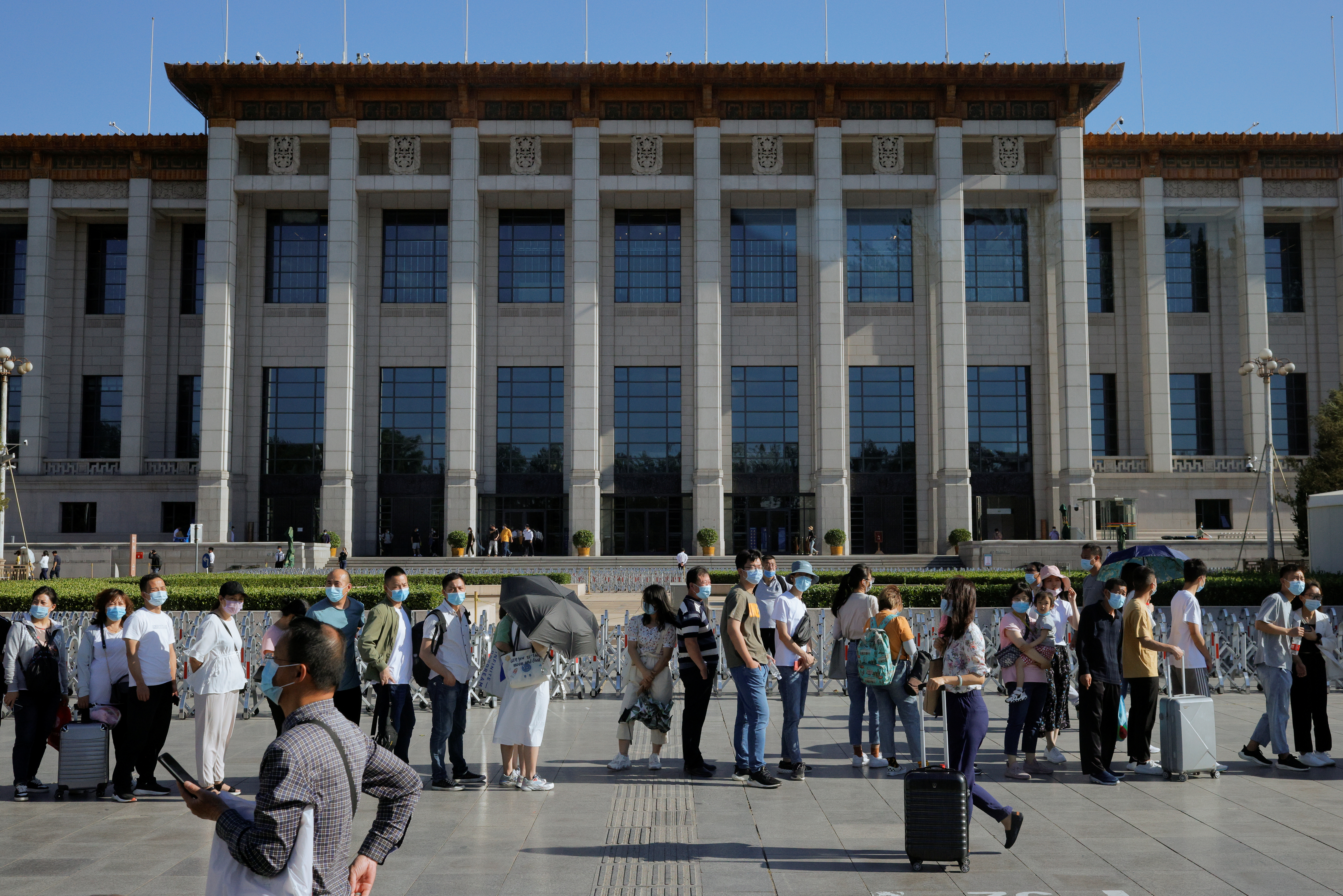 Tourists line up at a security check to enter Tiananmen Square in front of the National Museum of China in Beijing