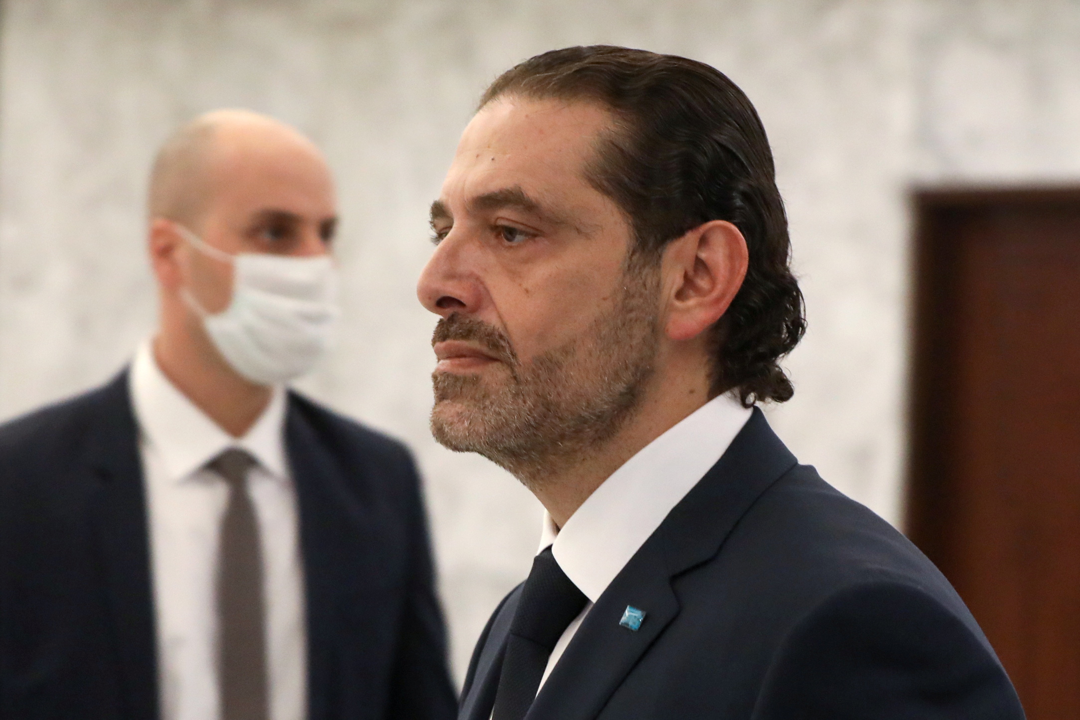 Prime Minister-designate Saad al-Hariri walks after meeting with Lebanon's President Michel Aoun at the presidential palace in Baabda