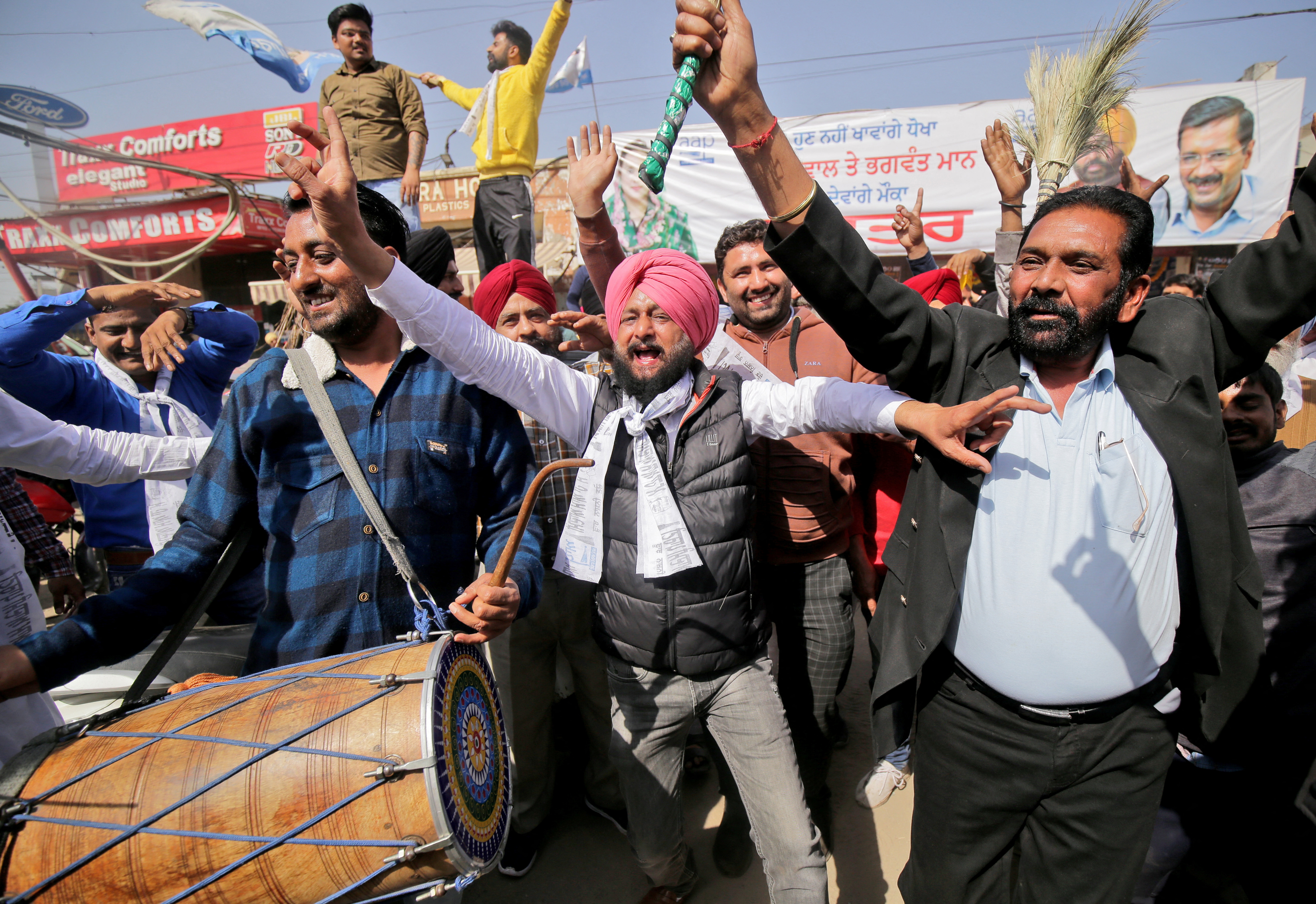 Supporters of AAP celebrate after learning of the initial poll results in Amritsar