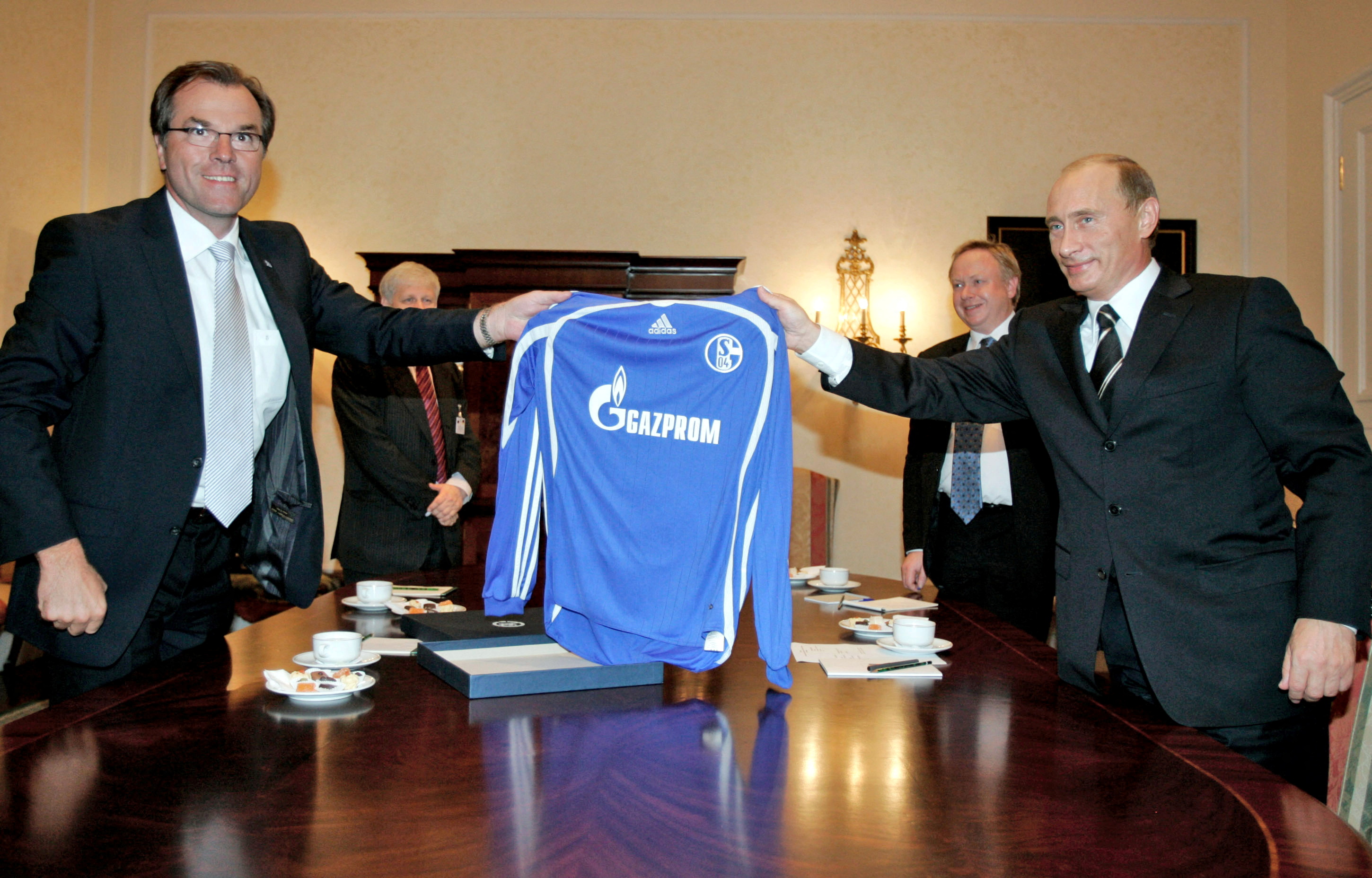 Toennies of German soccer club Schalke 04 and Russian President Putin hold jersey with Gazprom logo in Dresden