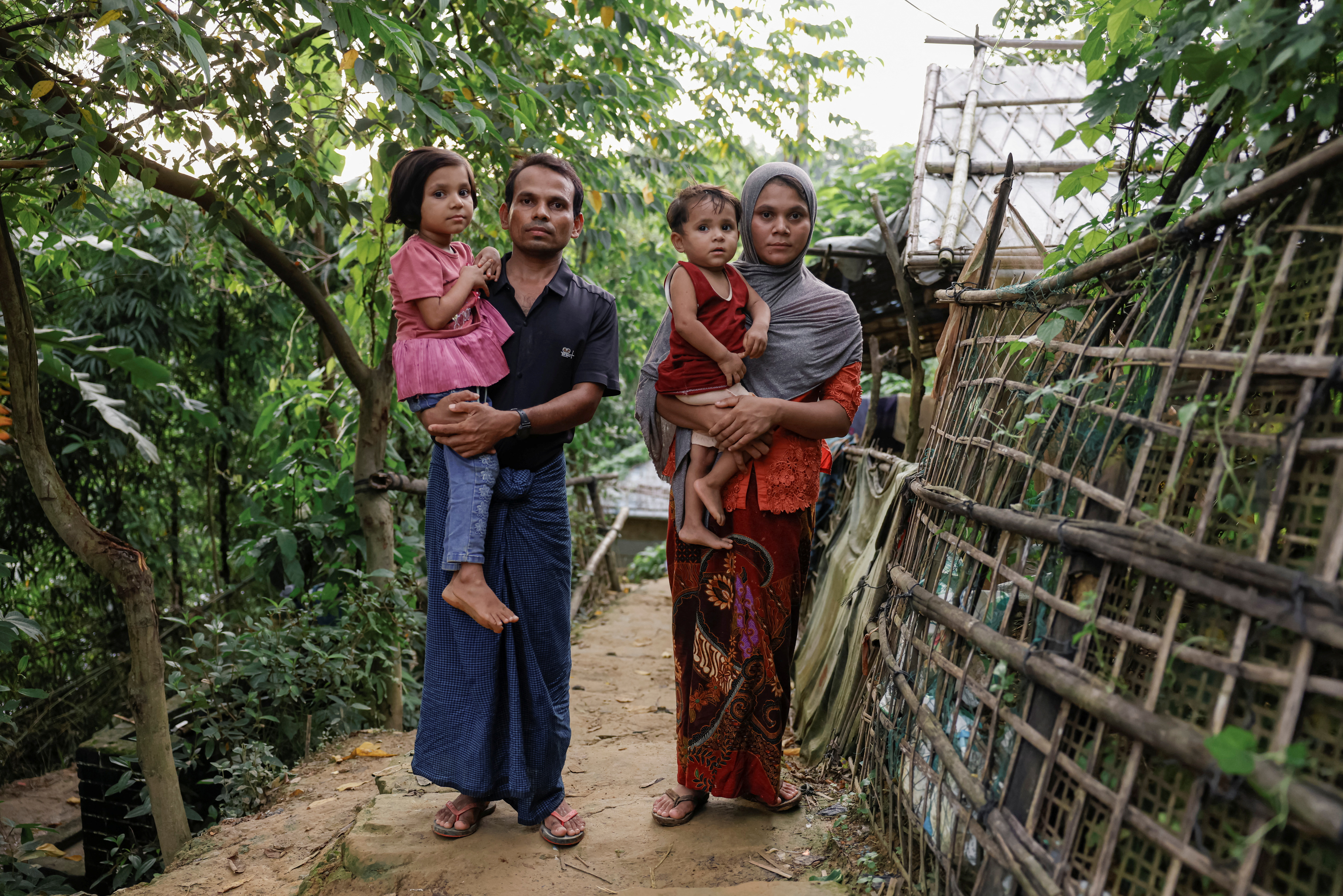 Saifur Rahman and his family, who said they fled from Buthidaung to Bangladesh, pose for a picture at a refugee camp in Cox's Bazar