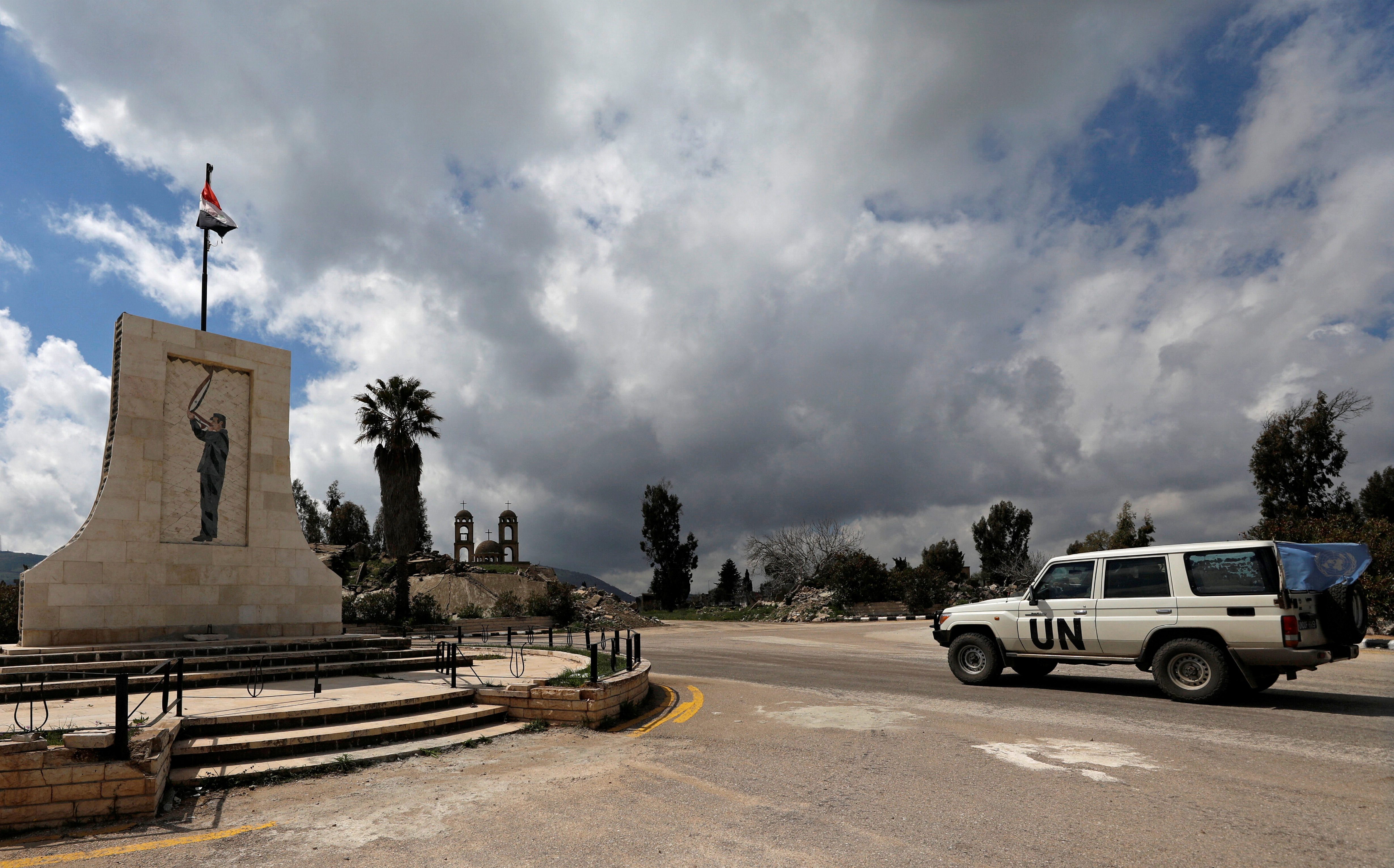 A U.N vehicle drives in Quneitra, near the Israeli-occupied Golan Heights