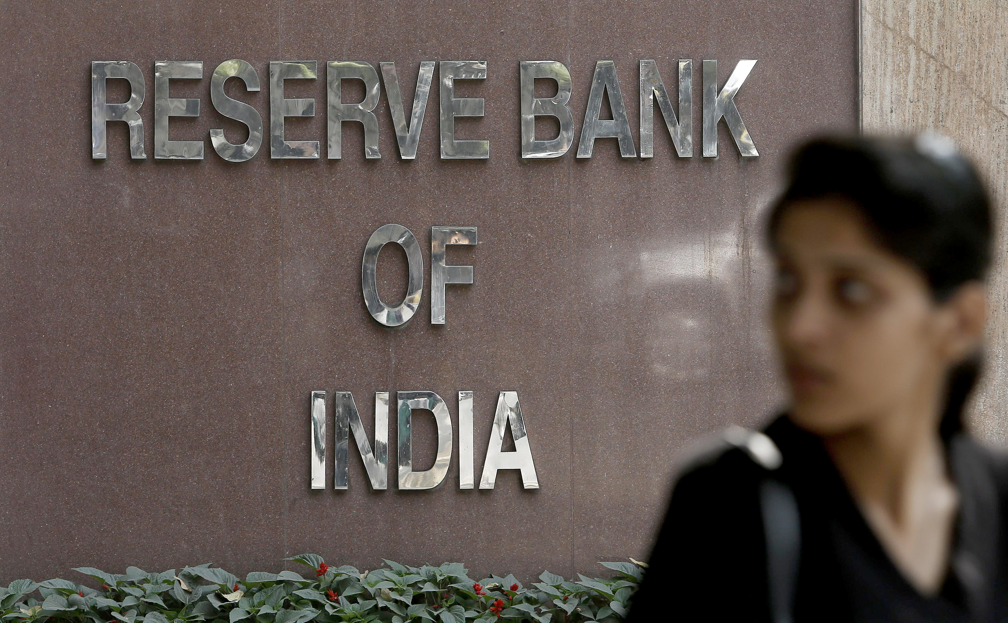 A woman walks past the Reserve Bank of India building in New Delhi