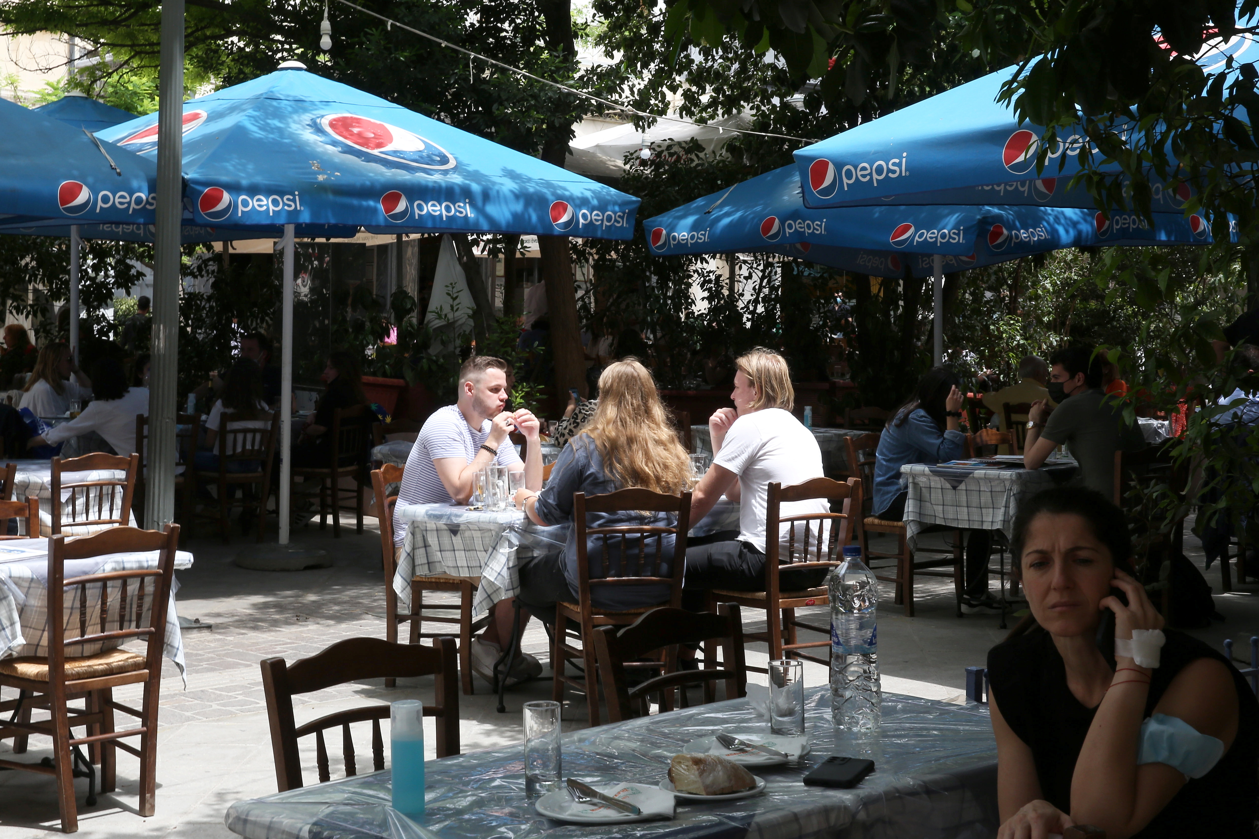 Tourists eat at Monastiraki district in Athens