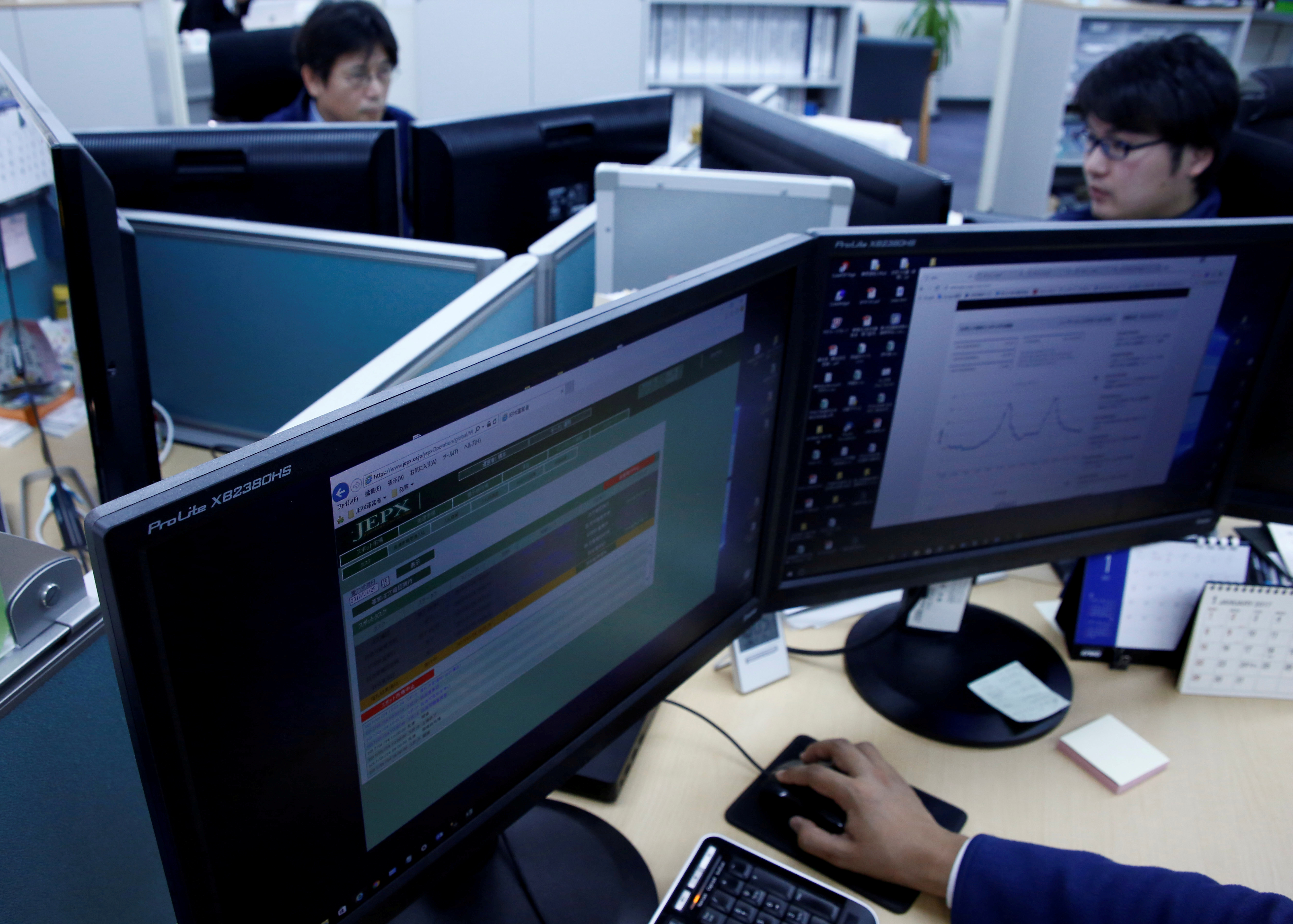 Employees work at Japan Electric Power Exchange's office in Tokyo