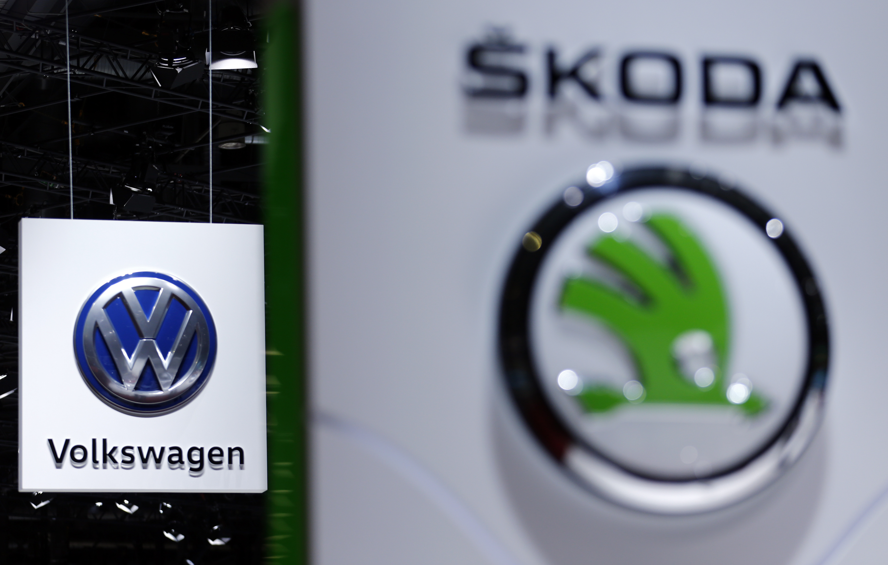 A Volkswagen (VW) logo is pictured next to a logo of Skoda during the second media day of the 86th International Motor Show in Geneva, Switzerland, March 2, 2016.   REUTERS/Denis Balibouse