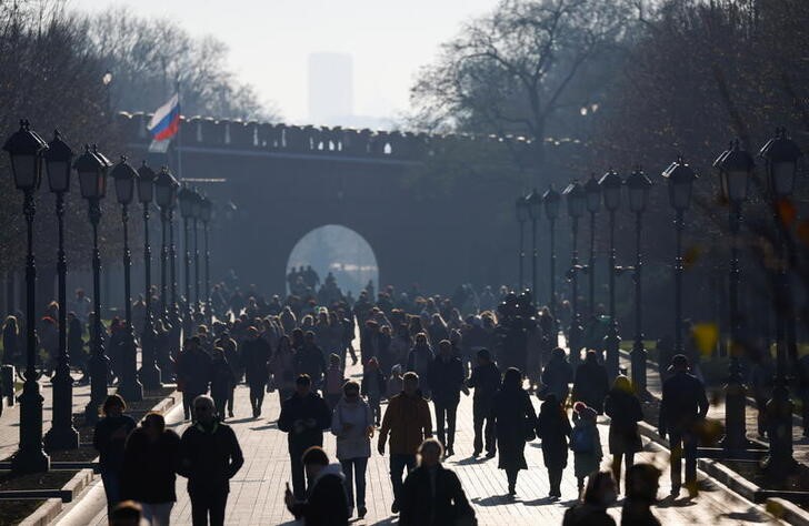 People walk near the Kremlin in central Moscow