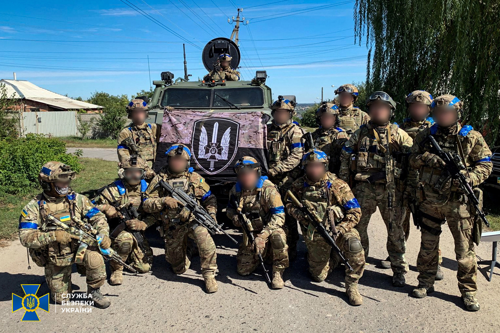 Service members of the State Security Service of Ukraine pose for a picture in the recently liberated town of Kupiansk