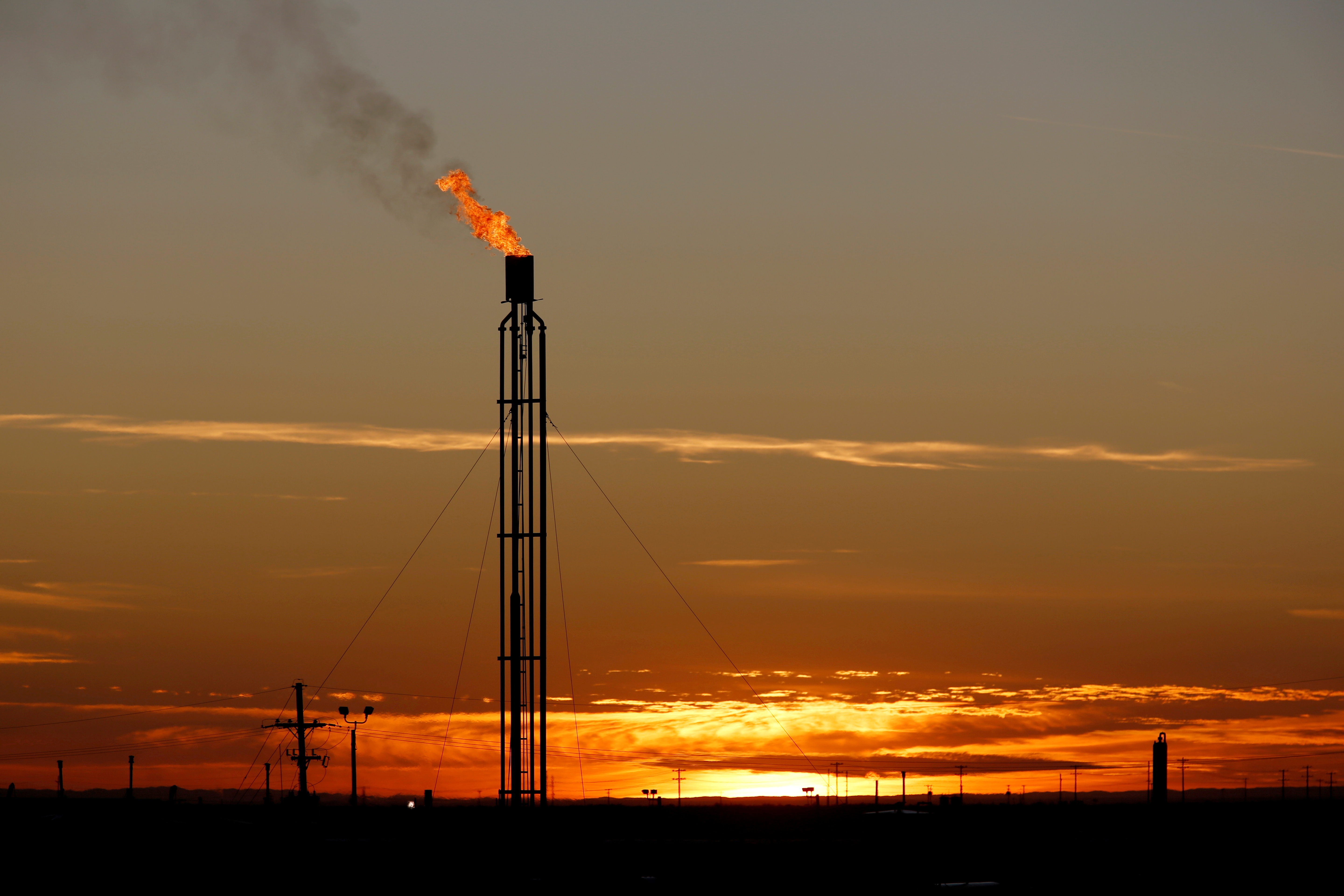 A flare burns excess natural gas in the Permian Basin in Loving County, Texas, U.S. November 23, 2019. Picture taken November 23, 2019. REUTERS/Angus Mordant//File Photo