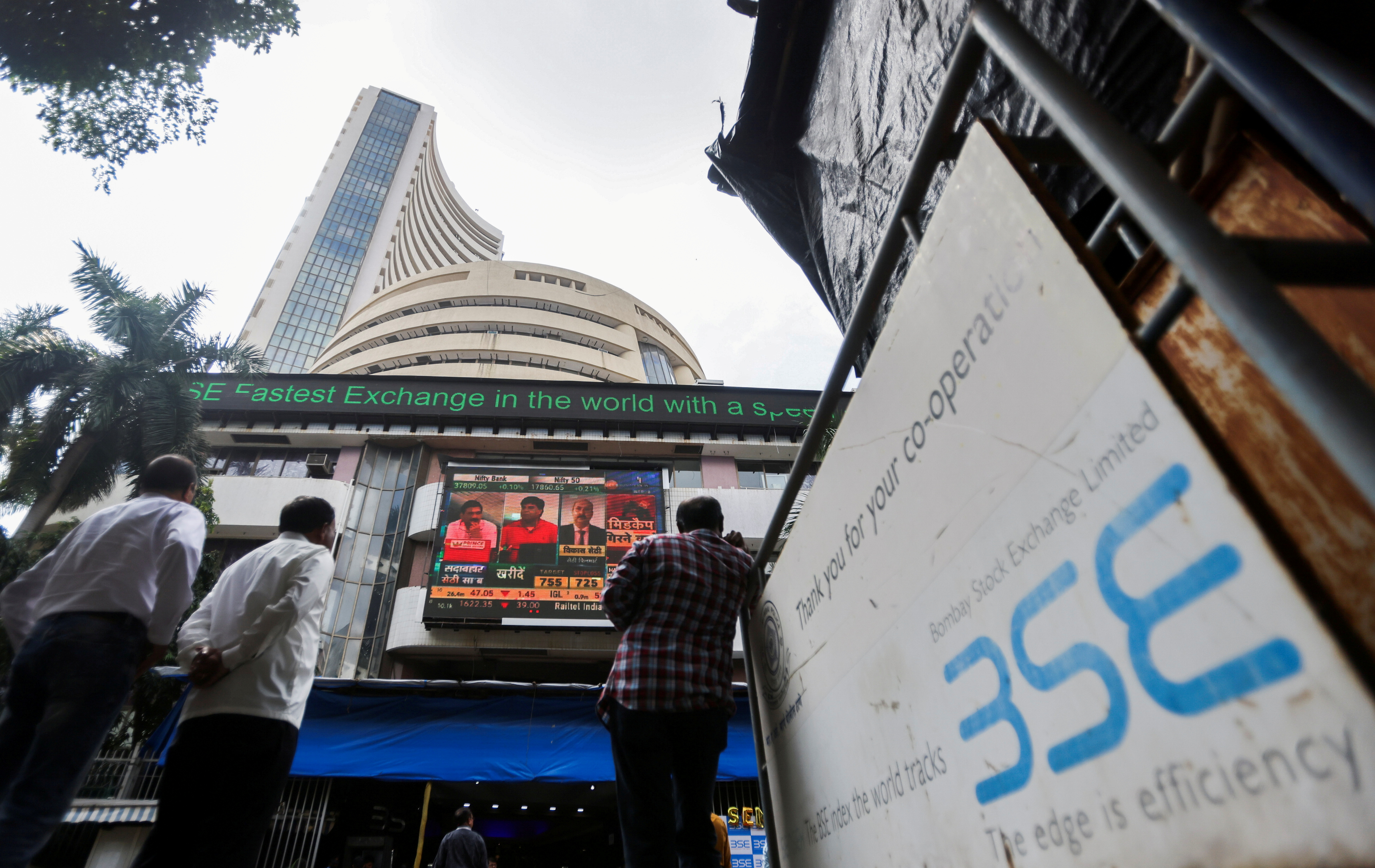 People stand outside the Bombay Stock Exchange (BSE), after Sensex surpassed the 60,000 level for the first time, in Mumbai, India, September 24, 2021. REUTERS/Francis Mascarenhas/File Photo