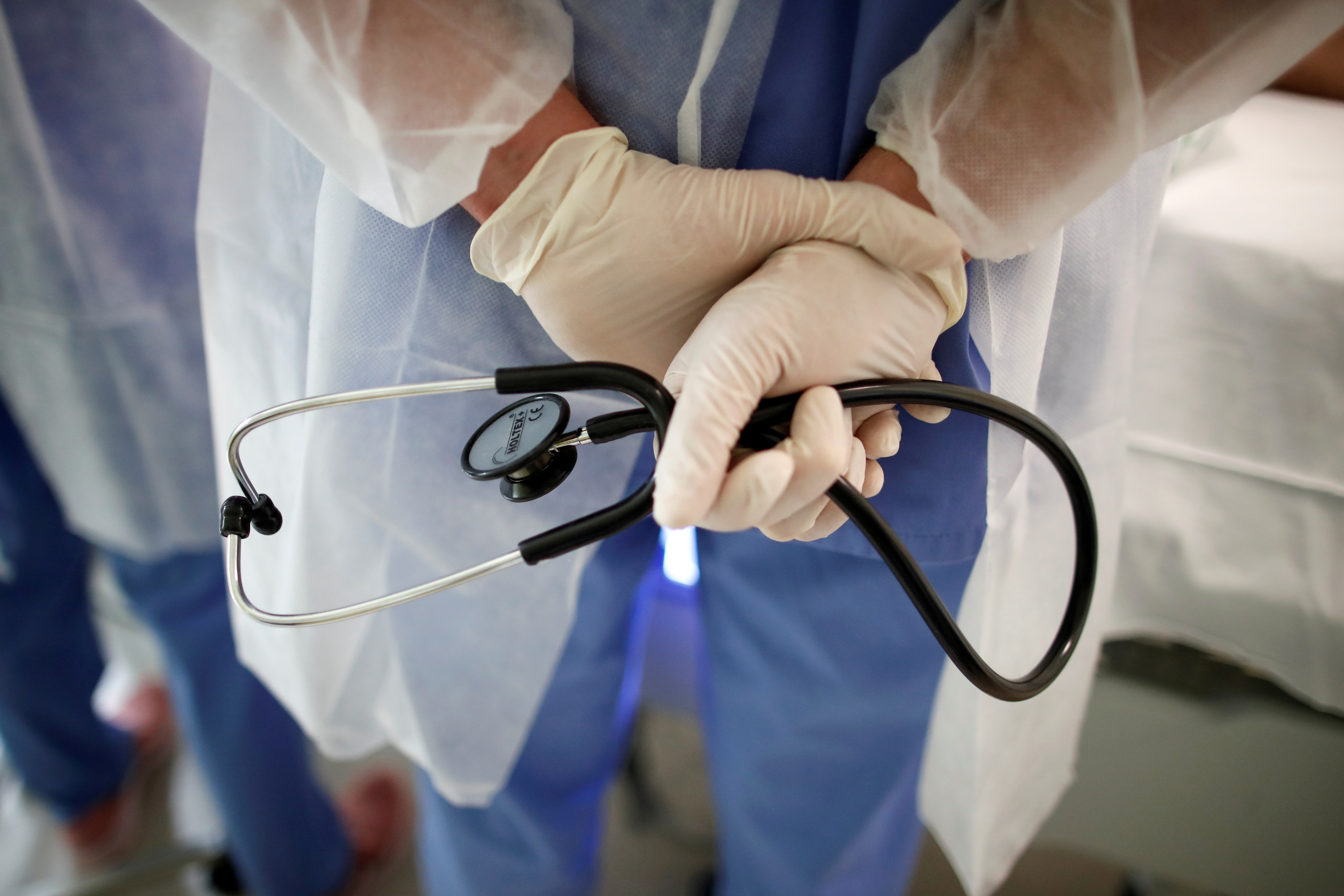 A doctor holds a stethoscope