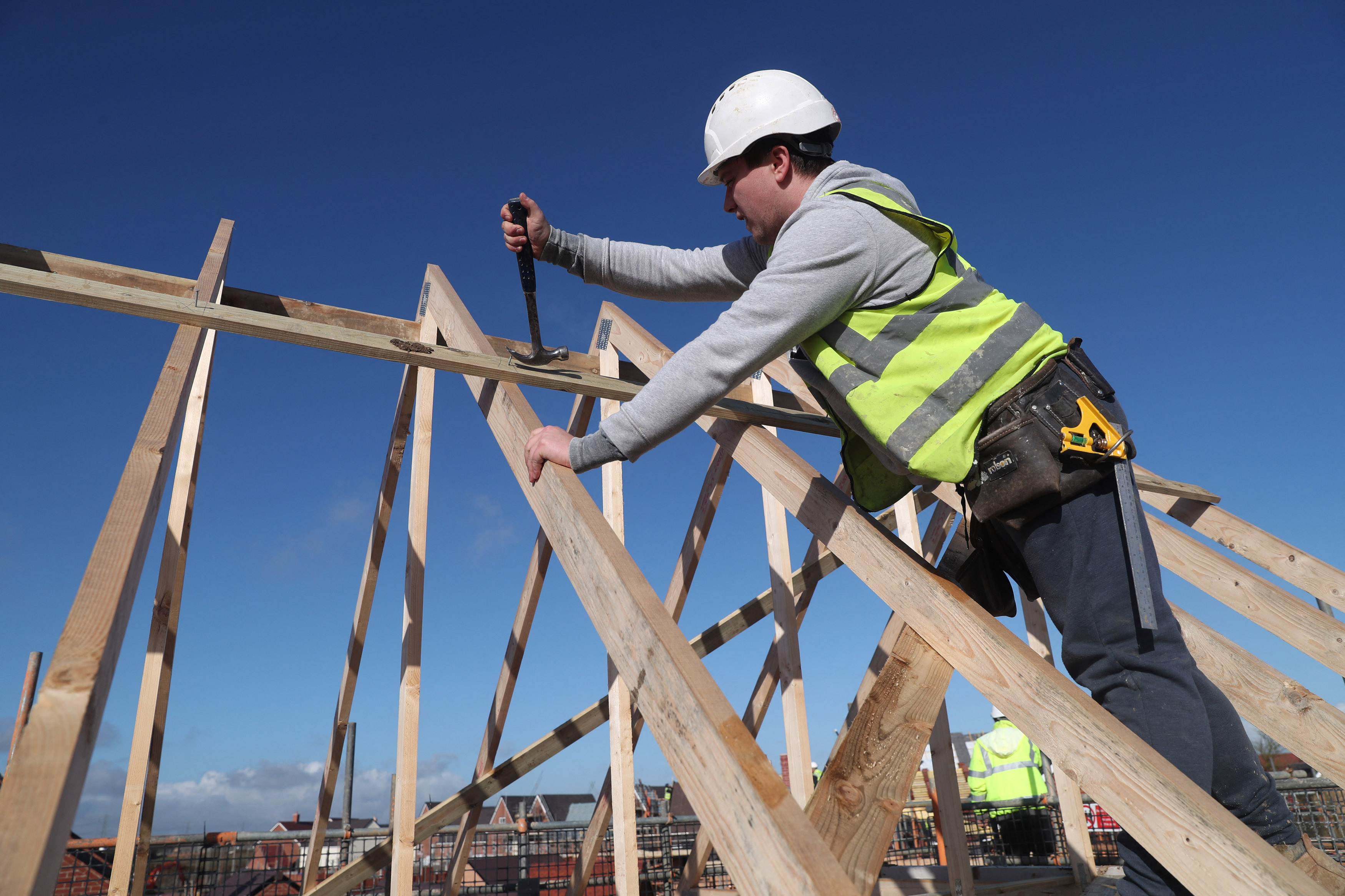 A builder works on a roof in Aylesbury, Britain, February 7, 2017. REUTERS/Eddie Keogh