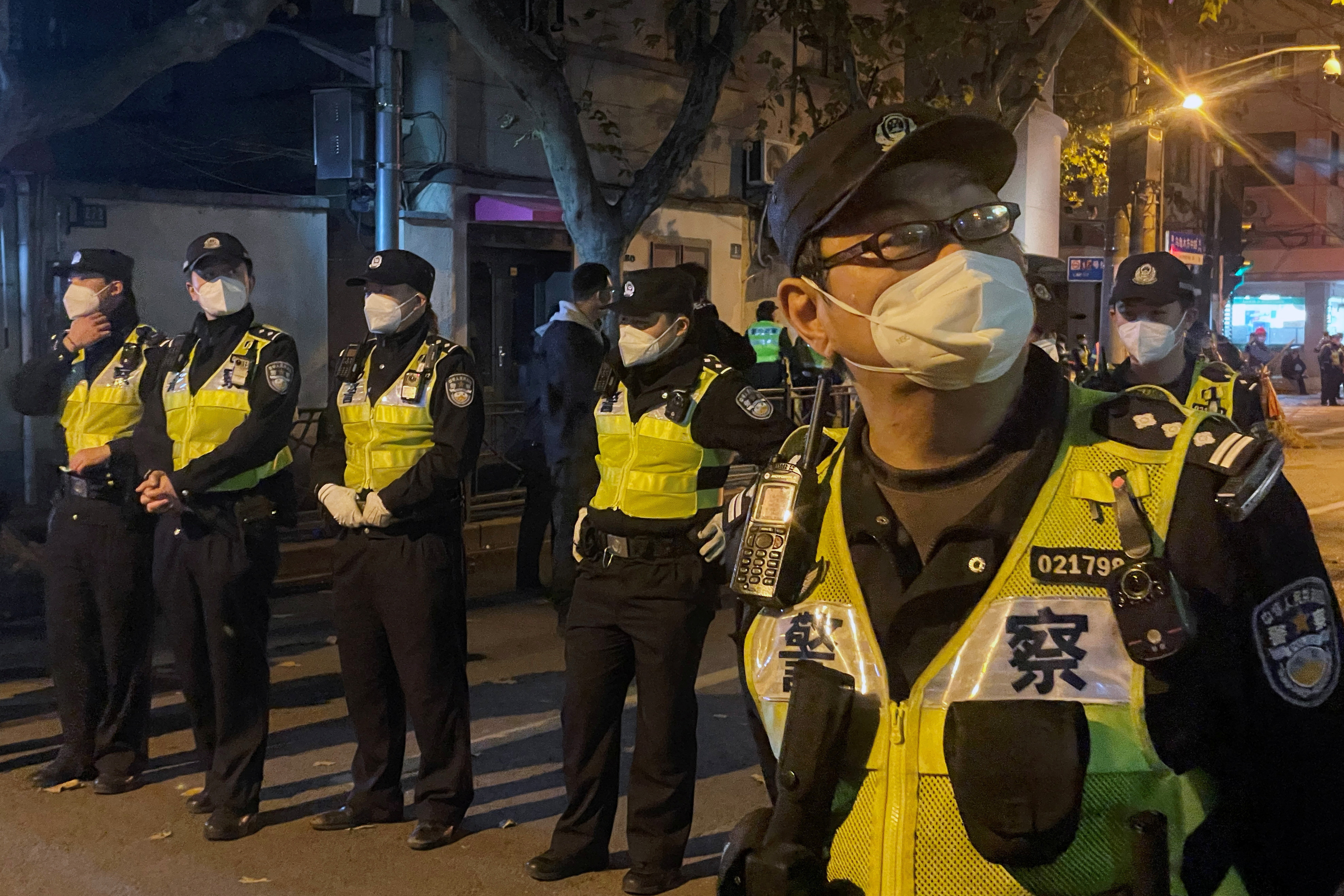 Police officers stand guard in Shanghai