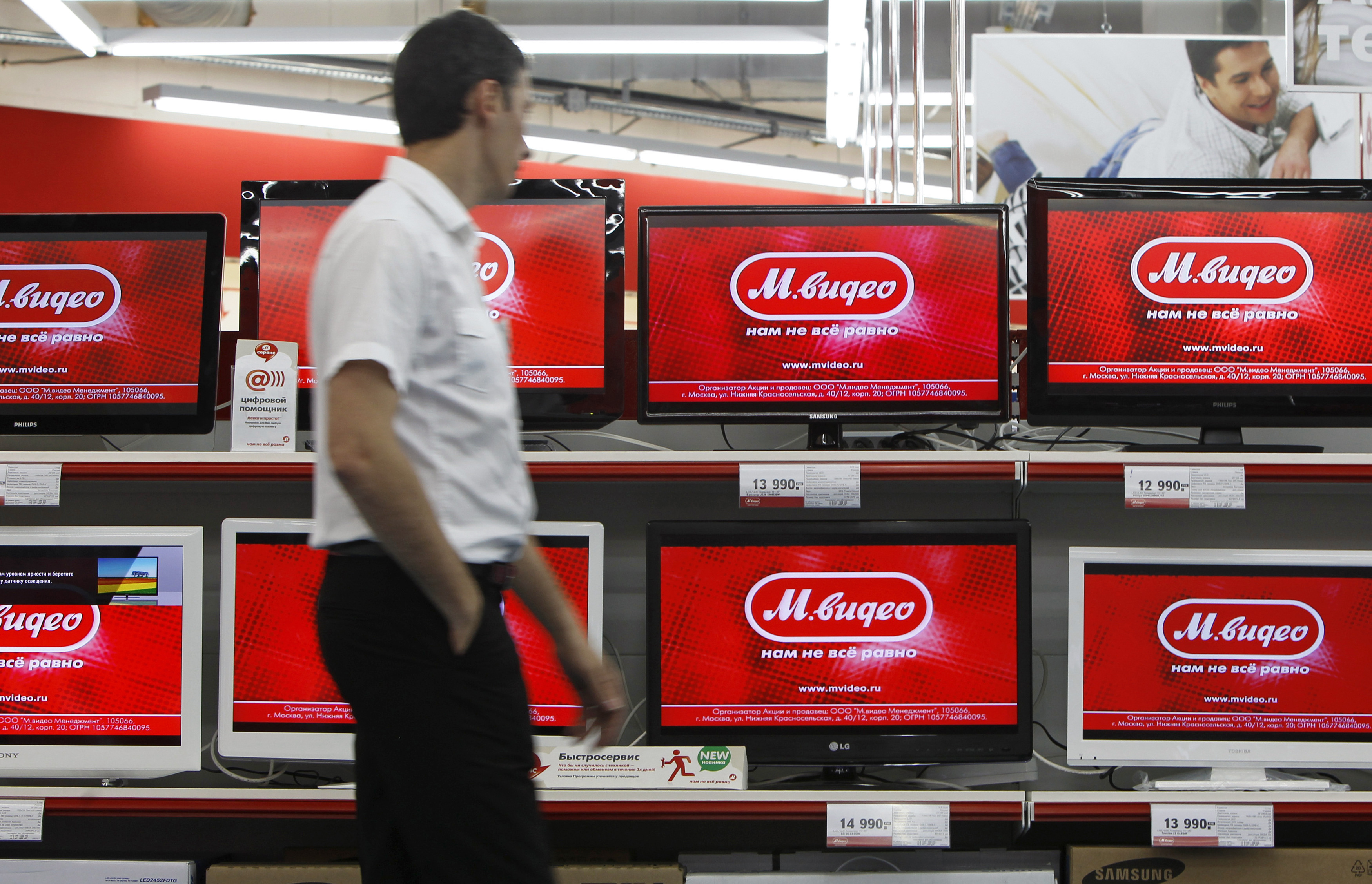 An employee walks inside a store of Russian home electronics retailer M.Video in Moscow