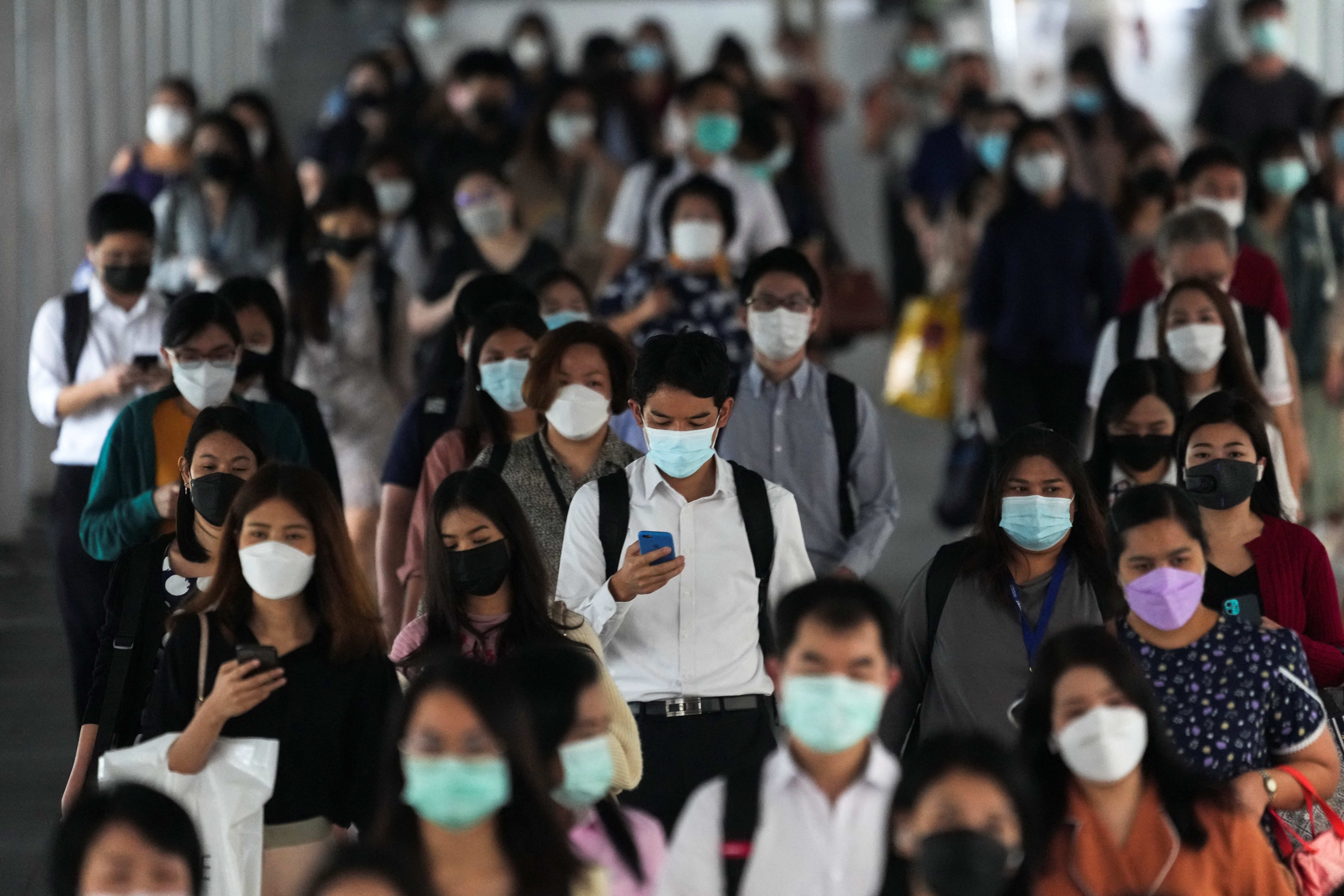 People wearing face masks as a measure to prevent the spread of the coronavirus disease (COVID-19) are seen at a train station in Bangkok, Thailand November 29, 2021. REUTERS/Athit Perawongmetha