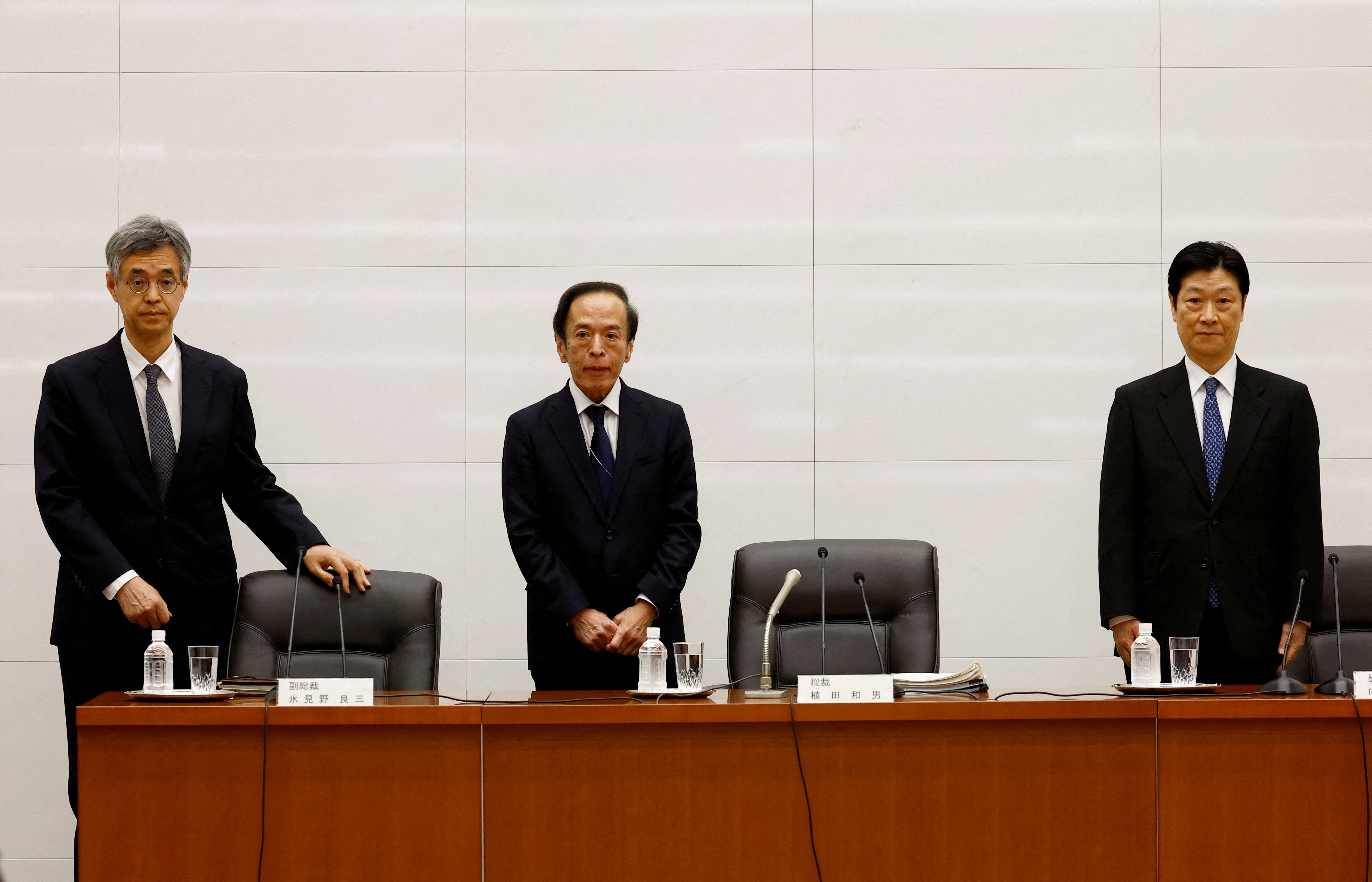 New Bank of Japan Governor Kazuo Ueda and Deputy Governors Ryozo Himino and Shinichi Uchida attend a news conference at the bank headquarters in Tokyo
