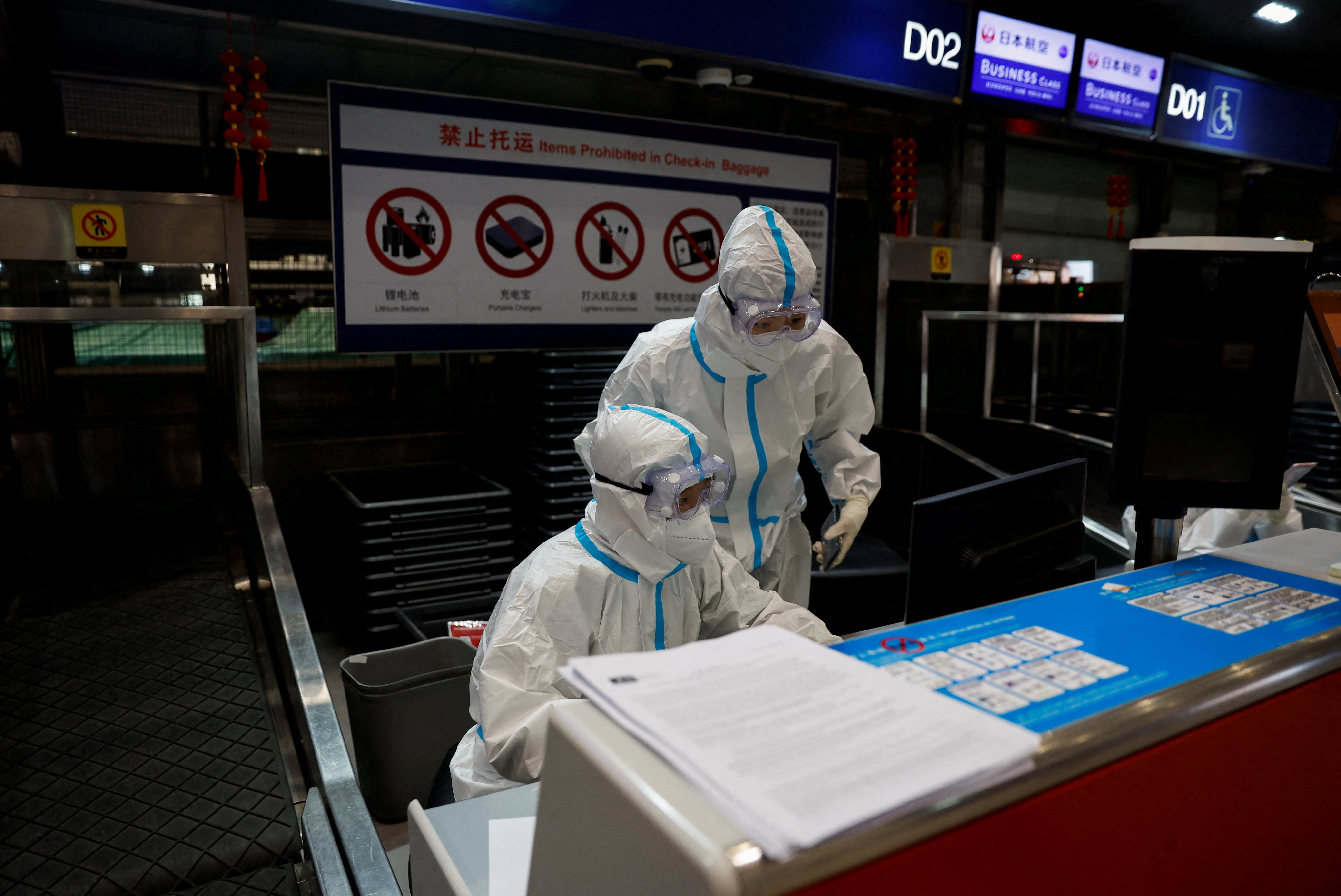 Airline staff wear personal protective equipment to protect against COVID-19, in Beijing