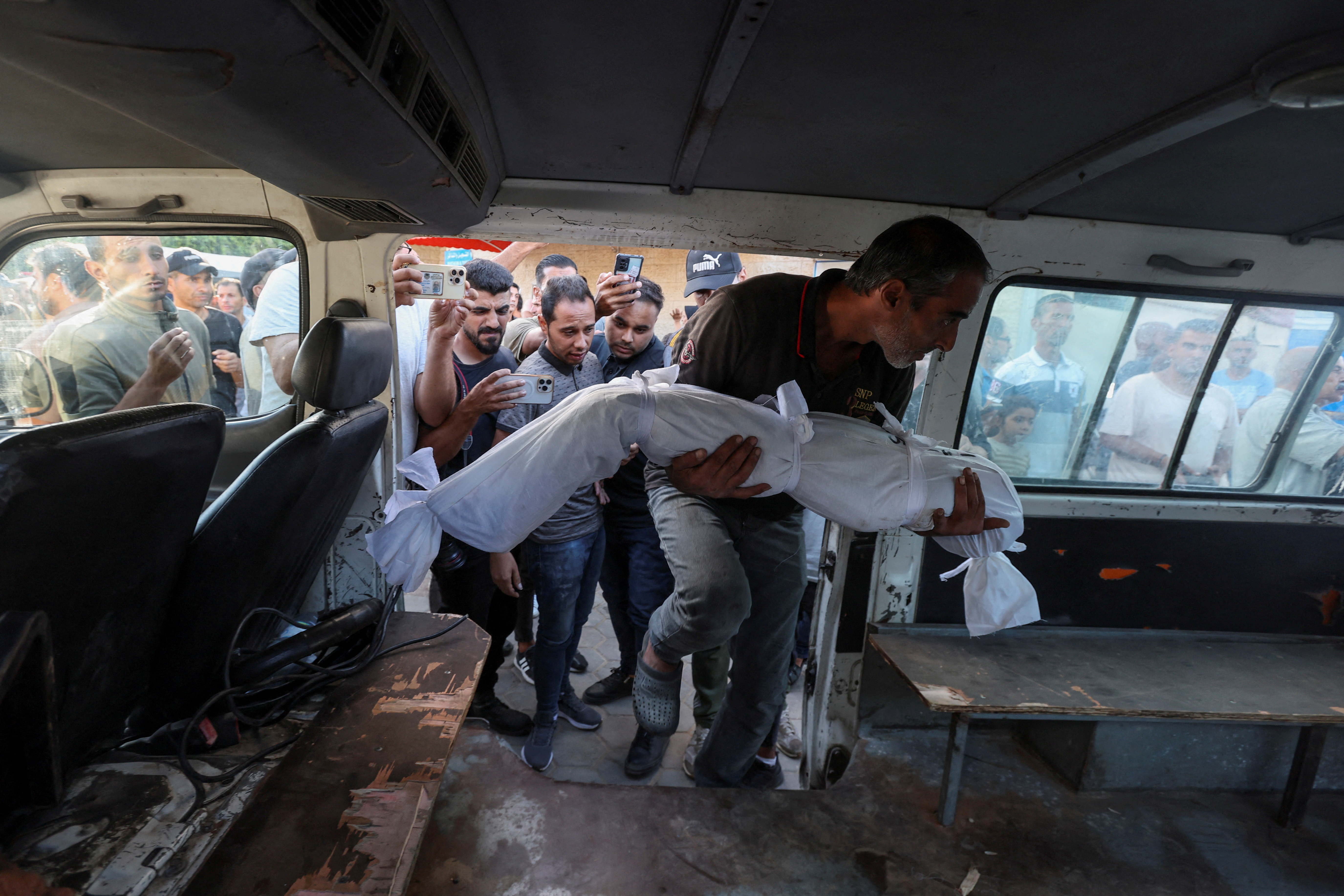 Palestinians mourn loved ones killed in Israeli strikes, in Deir Al-Balah in the central Gaza Strip