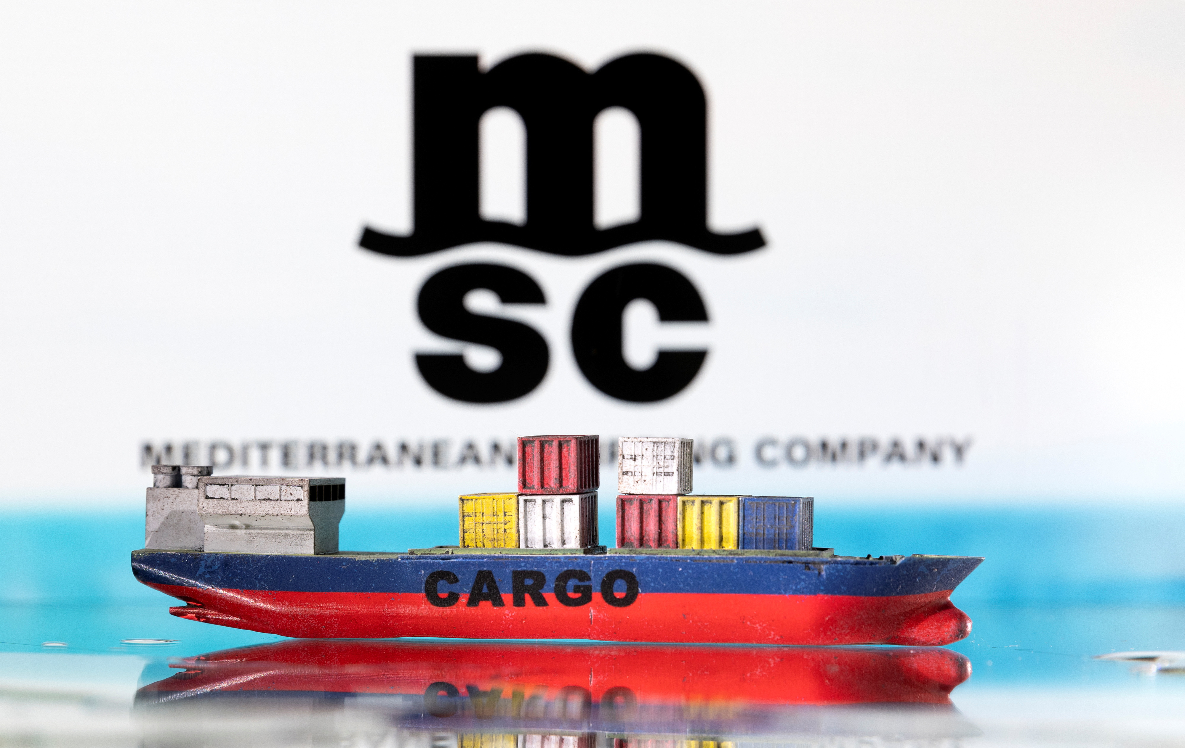 Illustration shows cargo boat model and Mediterranean Shipping Company (MSC) logo