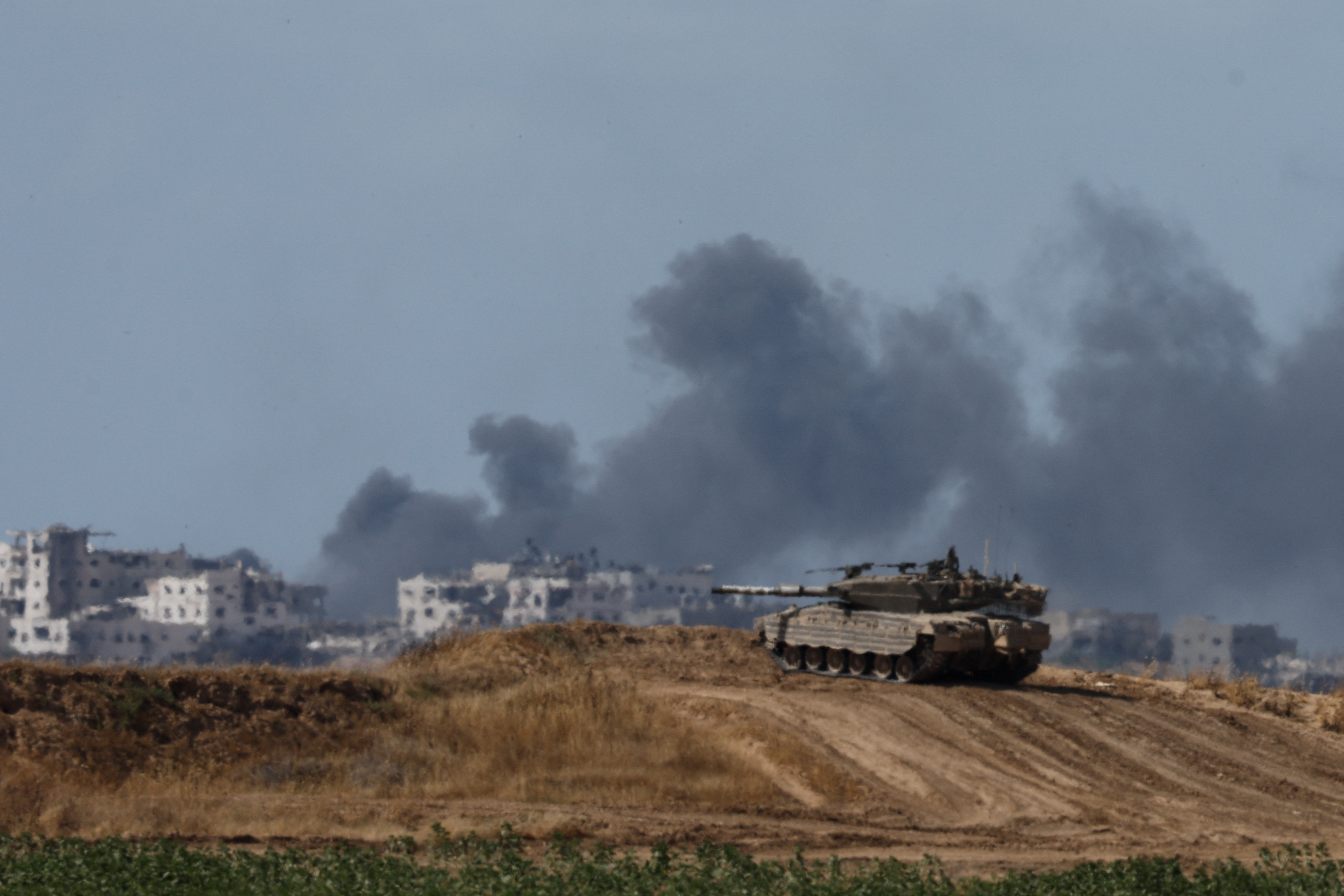 An Israeli tank holds a position, near the Israel-Gaza border