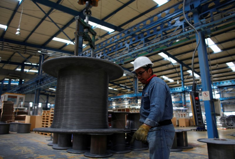 Worker holds stainless steel wire produced at TIM stainless steel wire factory in Huamantla