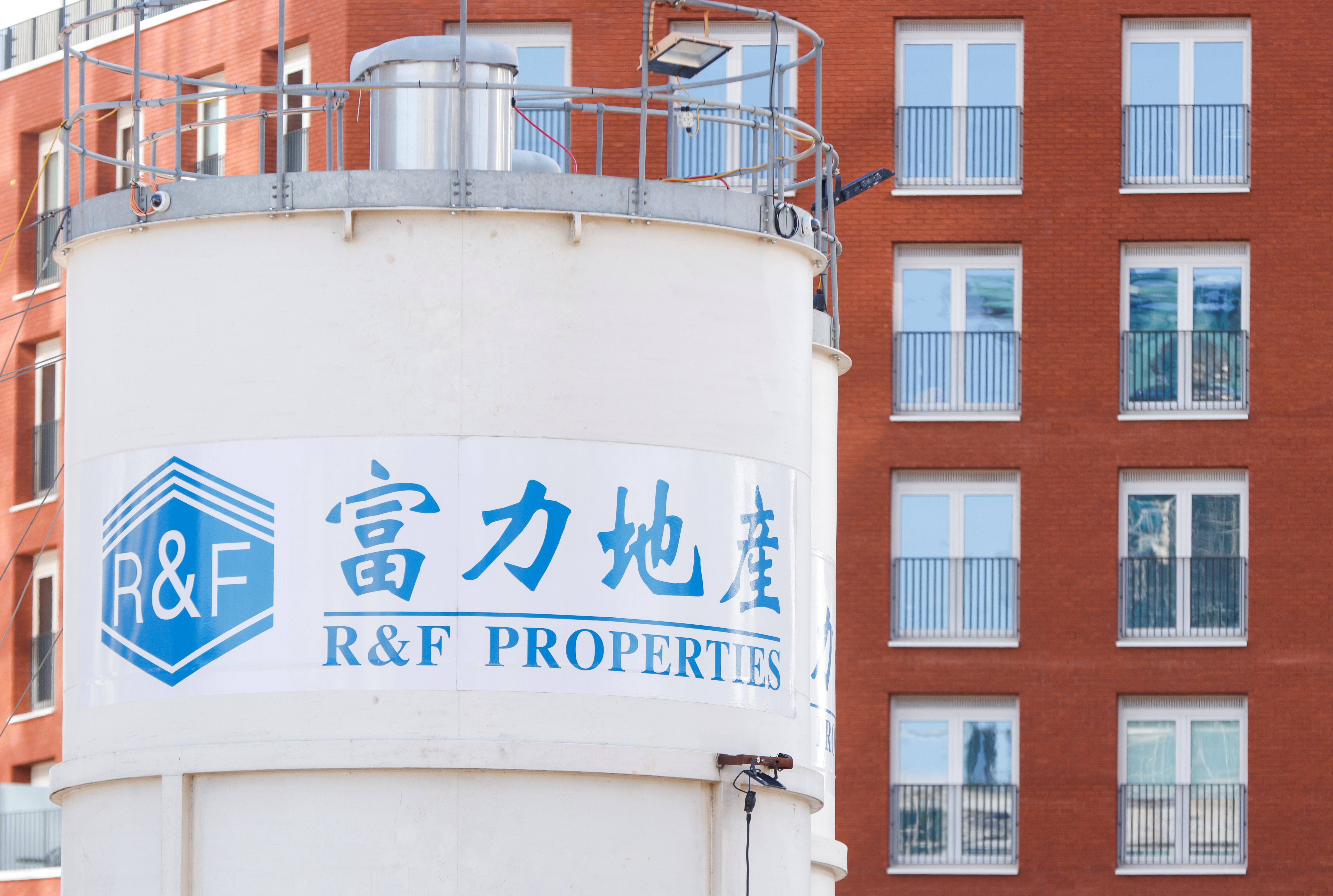 The logo of developer R&F Properties is seen near its One Thames City construction site at Nine Elms, in London