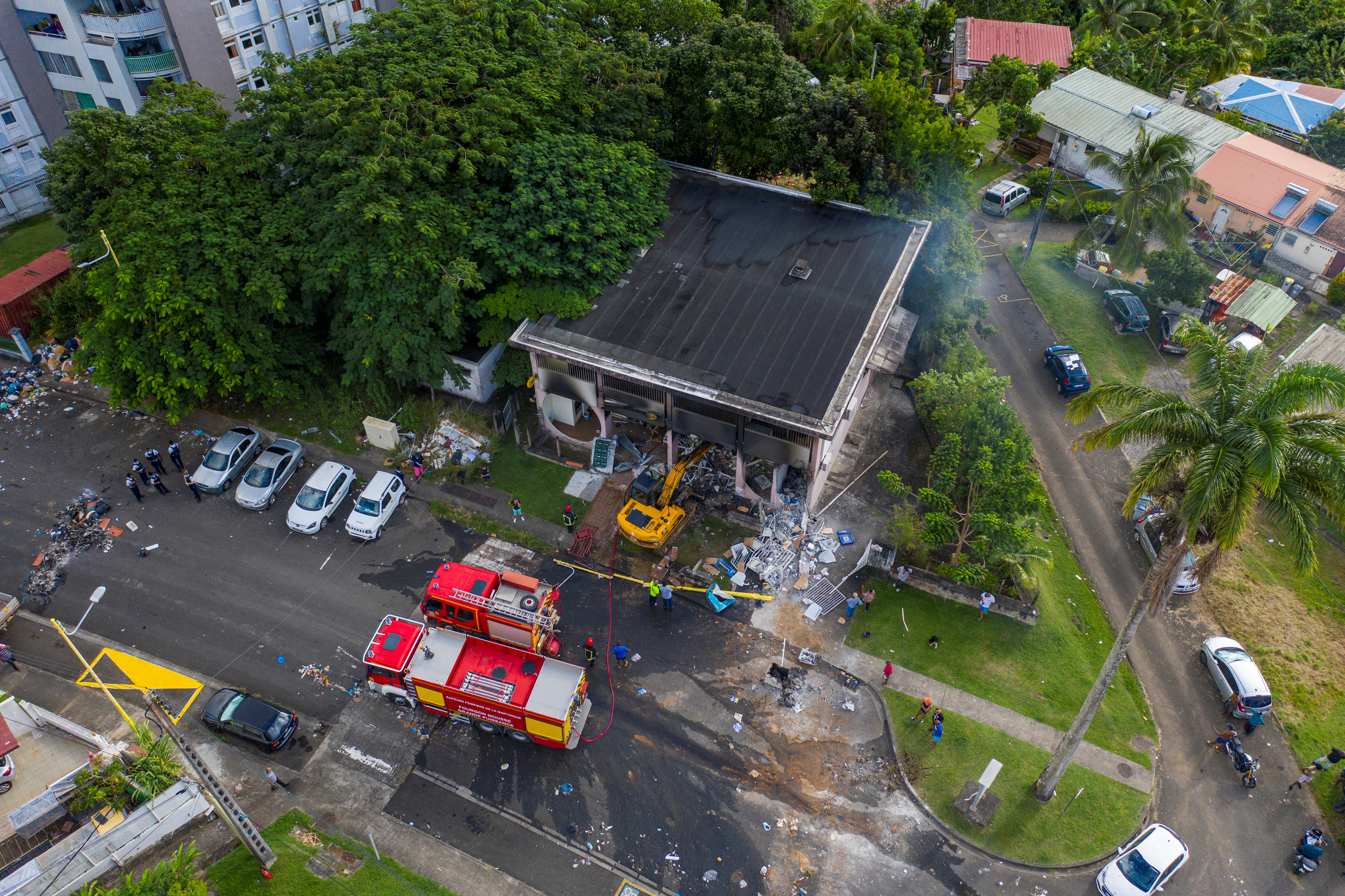 An aerial view shows a digger used to broke into a post office and to rip an ATM from the wall sitting outside in the neighborhood of Godissard after unrest triggered by COVID-19 curbs, which have already rocked the nearby island of Guadeloupe, in Fort-De-France, Martinique November 27, 2021. Picture taken with a drone. REUTERS/Ricardo Arduengo