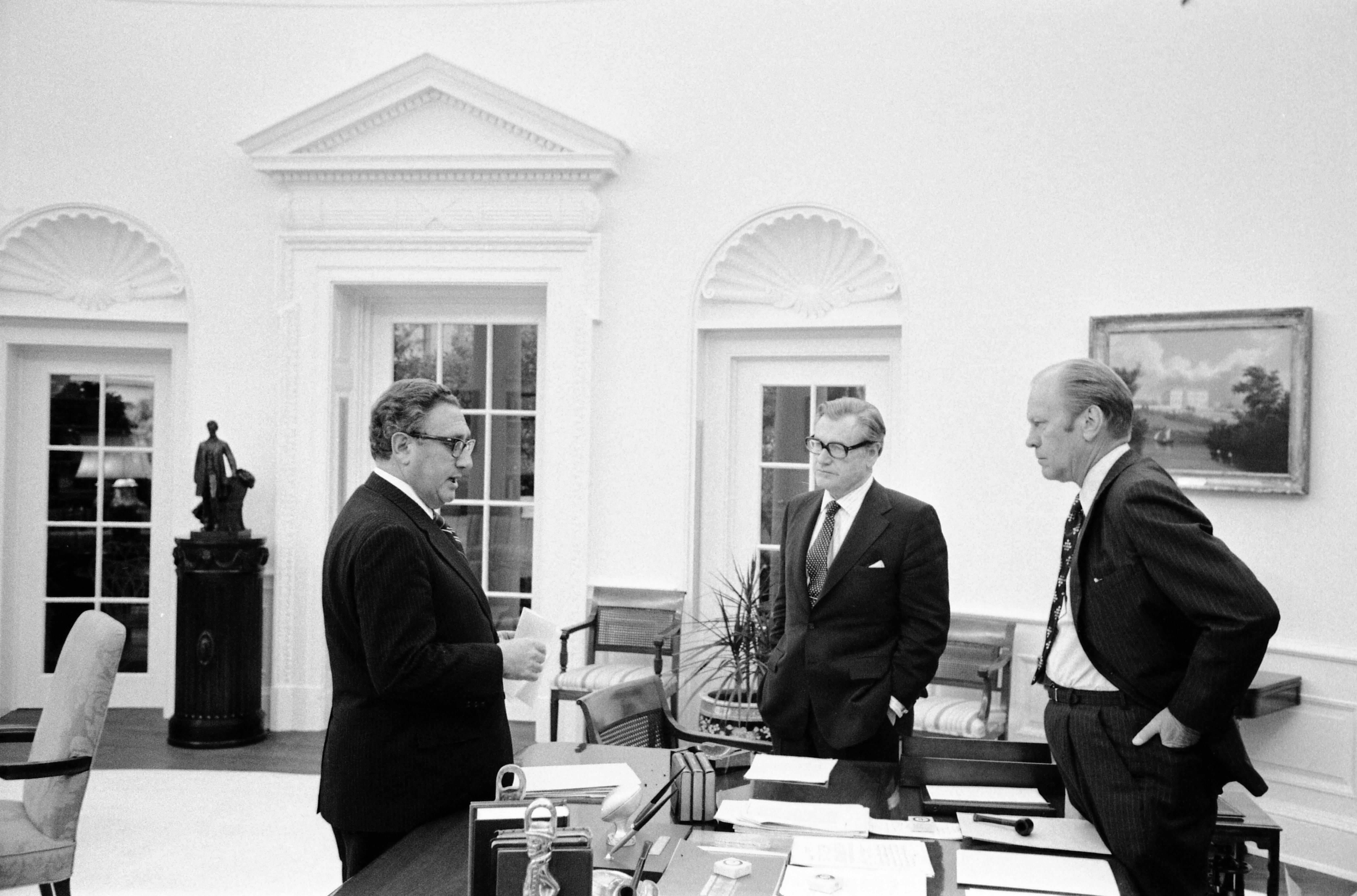 U.S. President Gerald Ford, Nelson A. Rockefeller and Henry A. Kissinger stand around the Oval Office desk prior to walking to the Roosevelt Room for a National Security Council Meeting on the the situation in South Vietnam, at the White House in Washington DC, U.S., April 28, 1975.  Gerald R. Ford Library/via REUTERS   