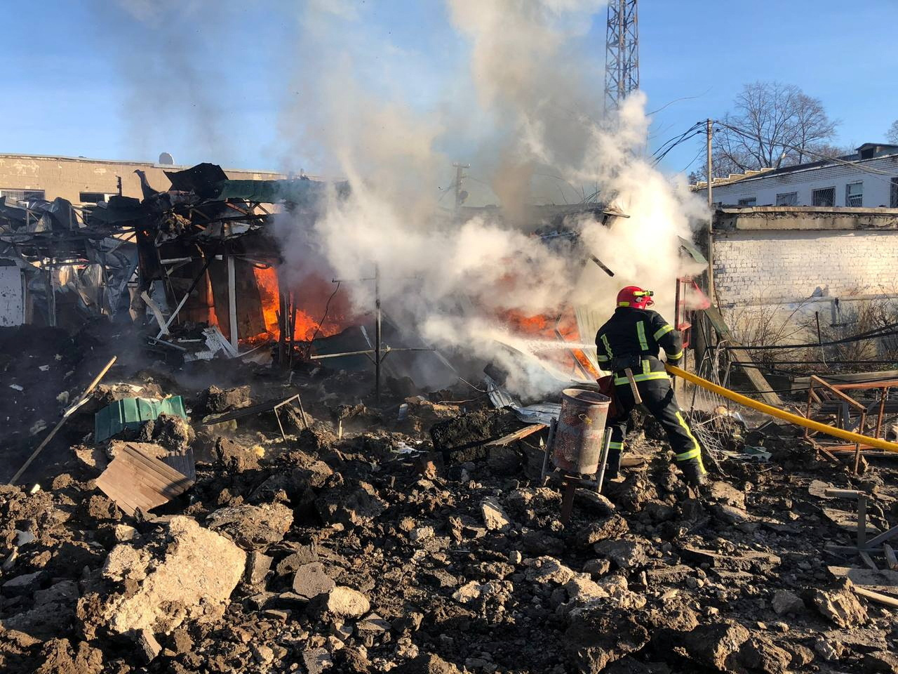 Firefighter works at a site of a market hit by Russian missiles in the town of Shevchenkove
