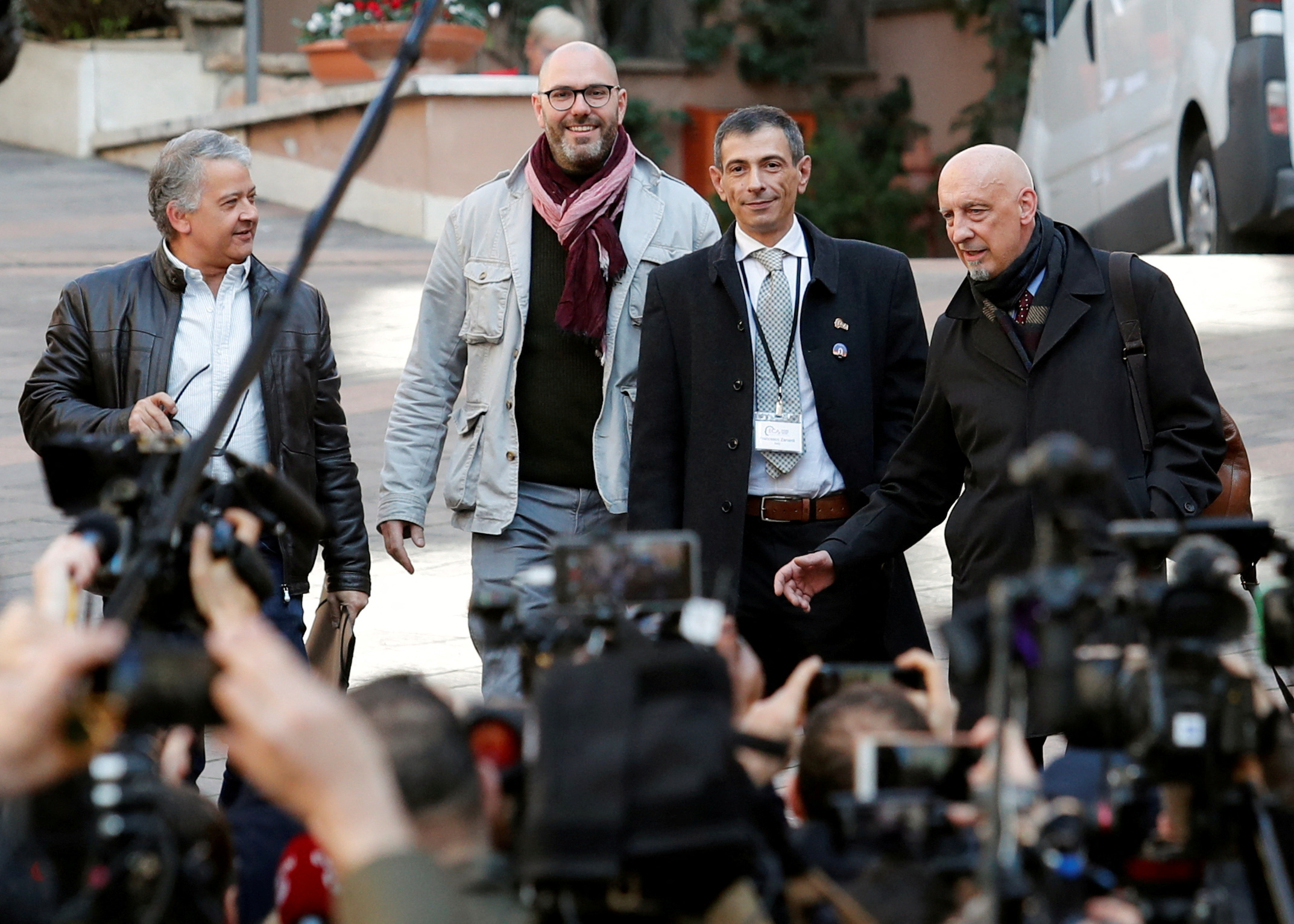 Pedro Salinas, Francois Devaux, Francesco Zanardi and Peter Iseley, survivors of sexual abuse, talk to reporters outside the Vatican in Rome