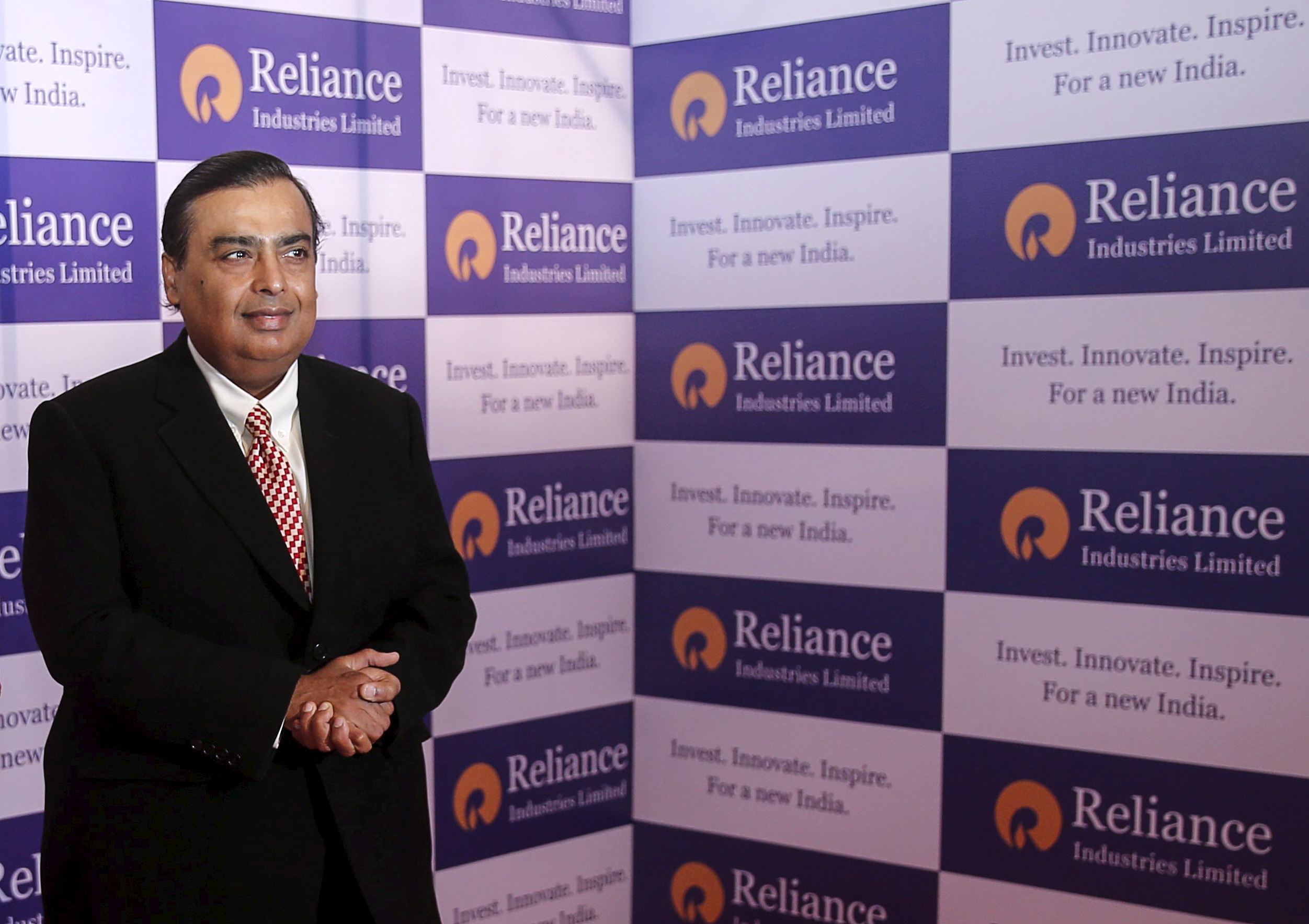 Mukesh Ambani, chairman of Reliance Industries Limited, poses for photographers before addressing the annual shareholders meeting in Mumbai