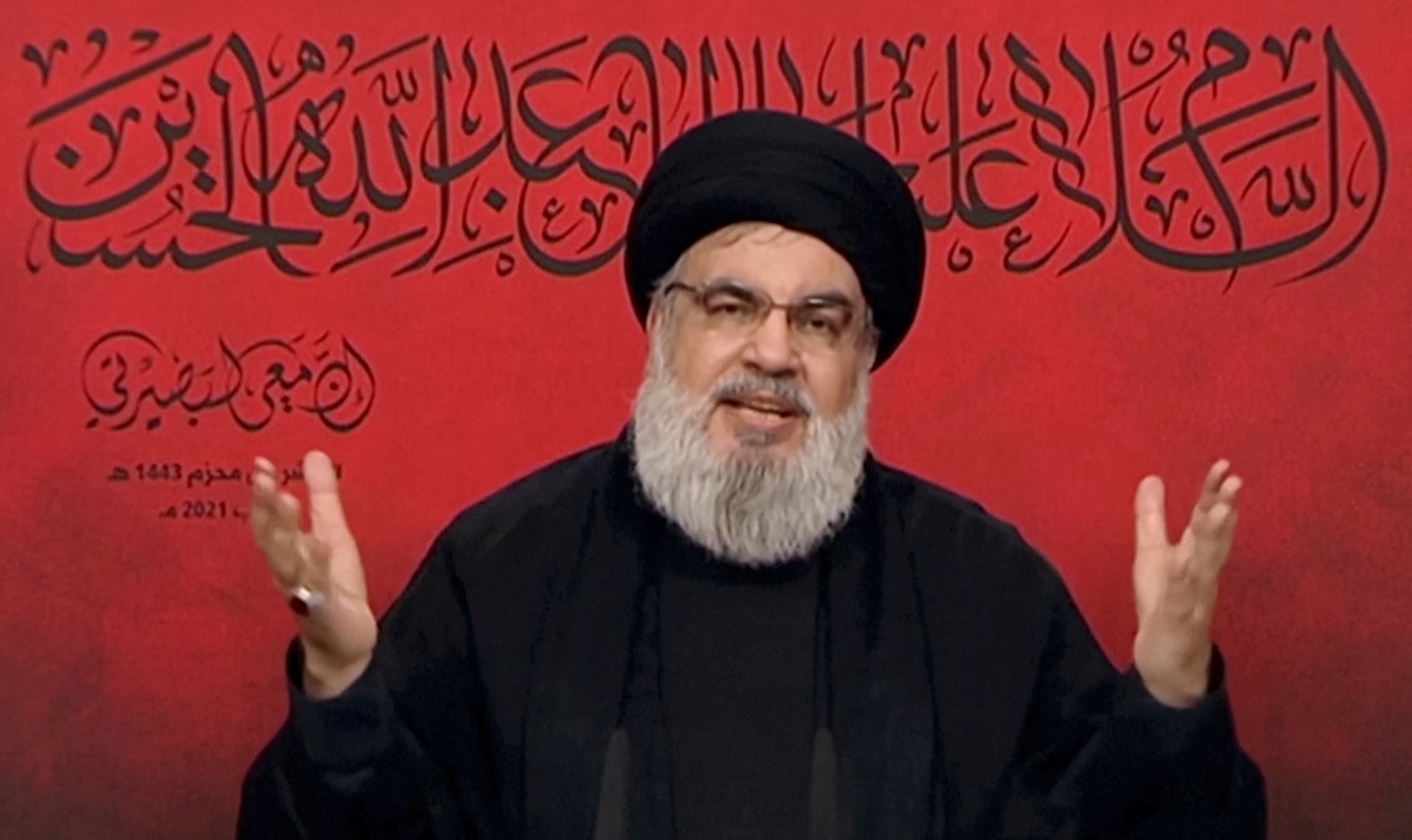 Lebanon's Hezbollah leader Sayyed Hassan Nasrallah speaks through a screen during a religious ceremony marking Ashura