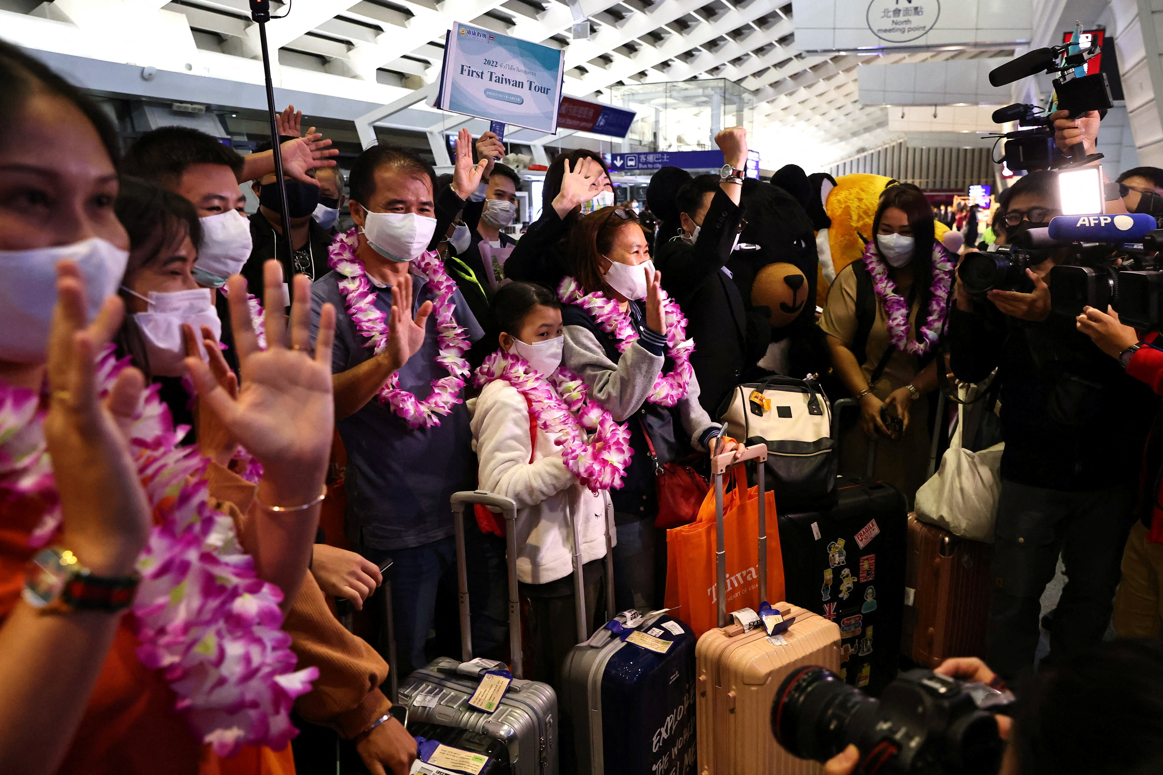 Travellers from Thailand on the first quarantine-free flight to Taiwan receive welcome by officials and the media at the airport in Taoyuan,