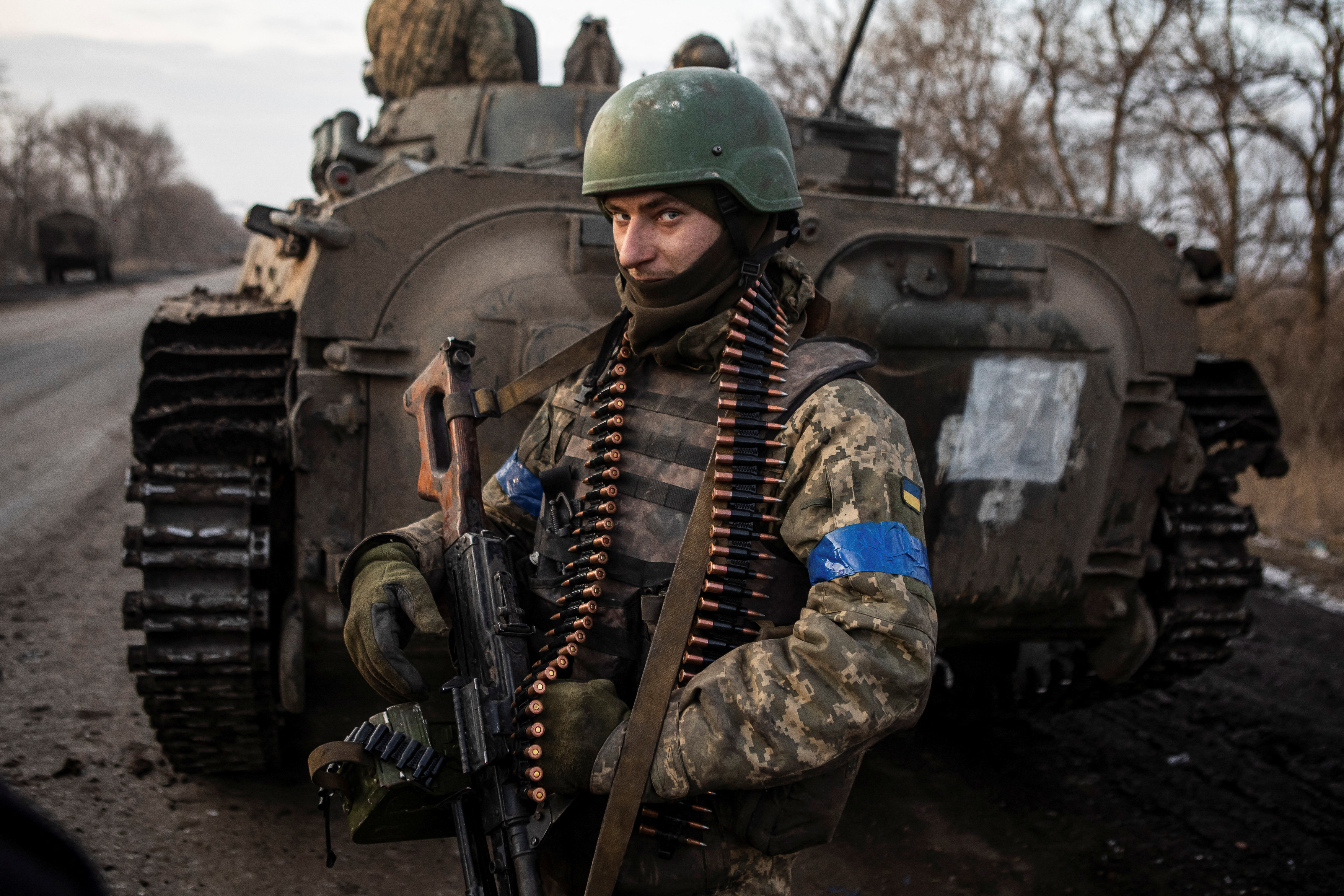 Ukrainian serviceman stands on road outside frontline town of Bakhmut