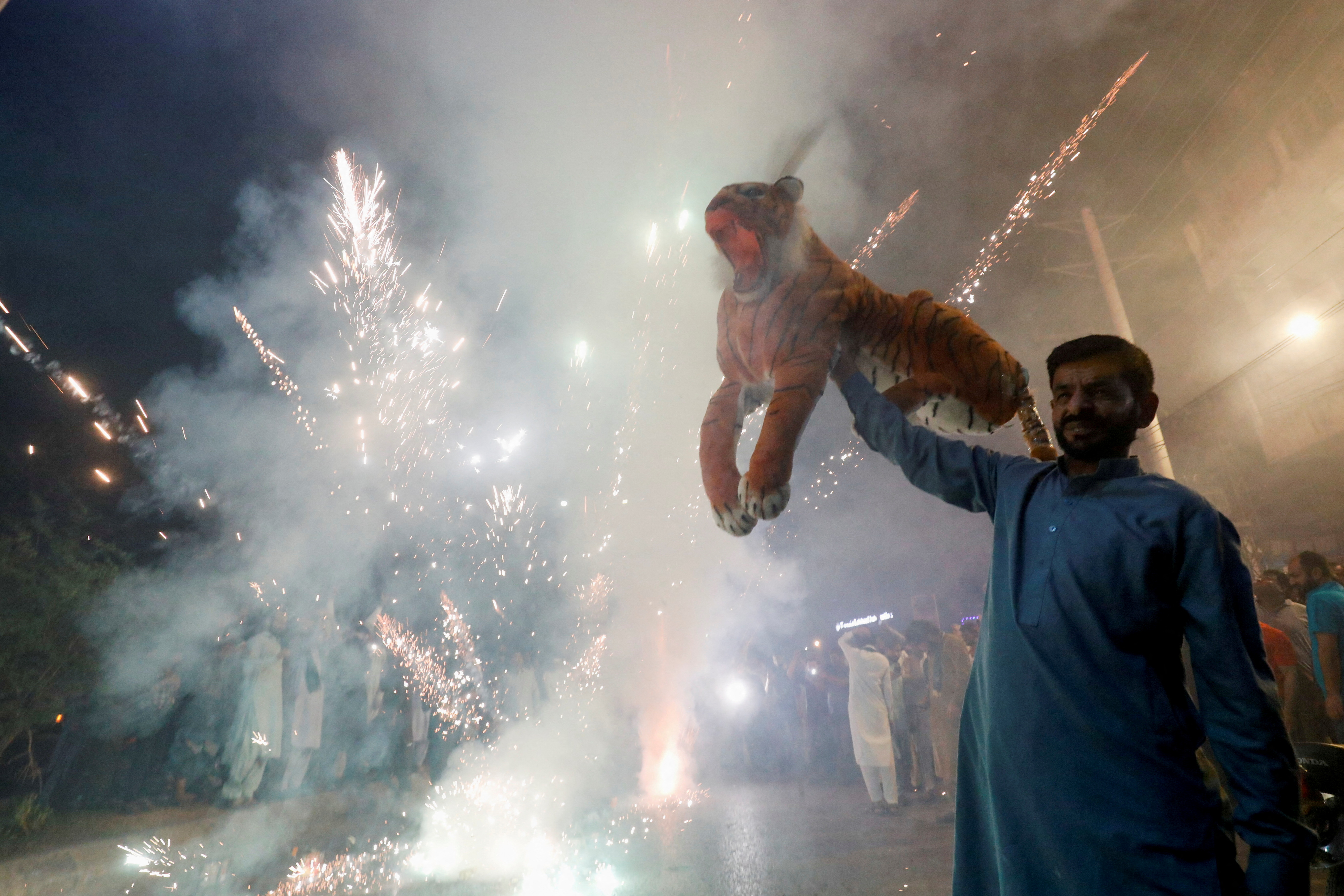People celebrate as Shehbaz Sharif sworn in as the country's prime minister, in Rawalpindi,