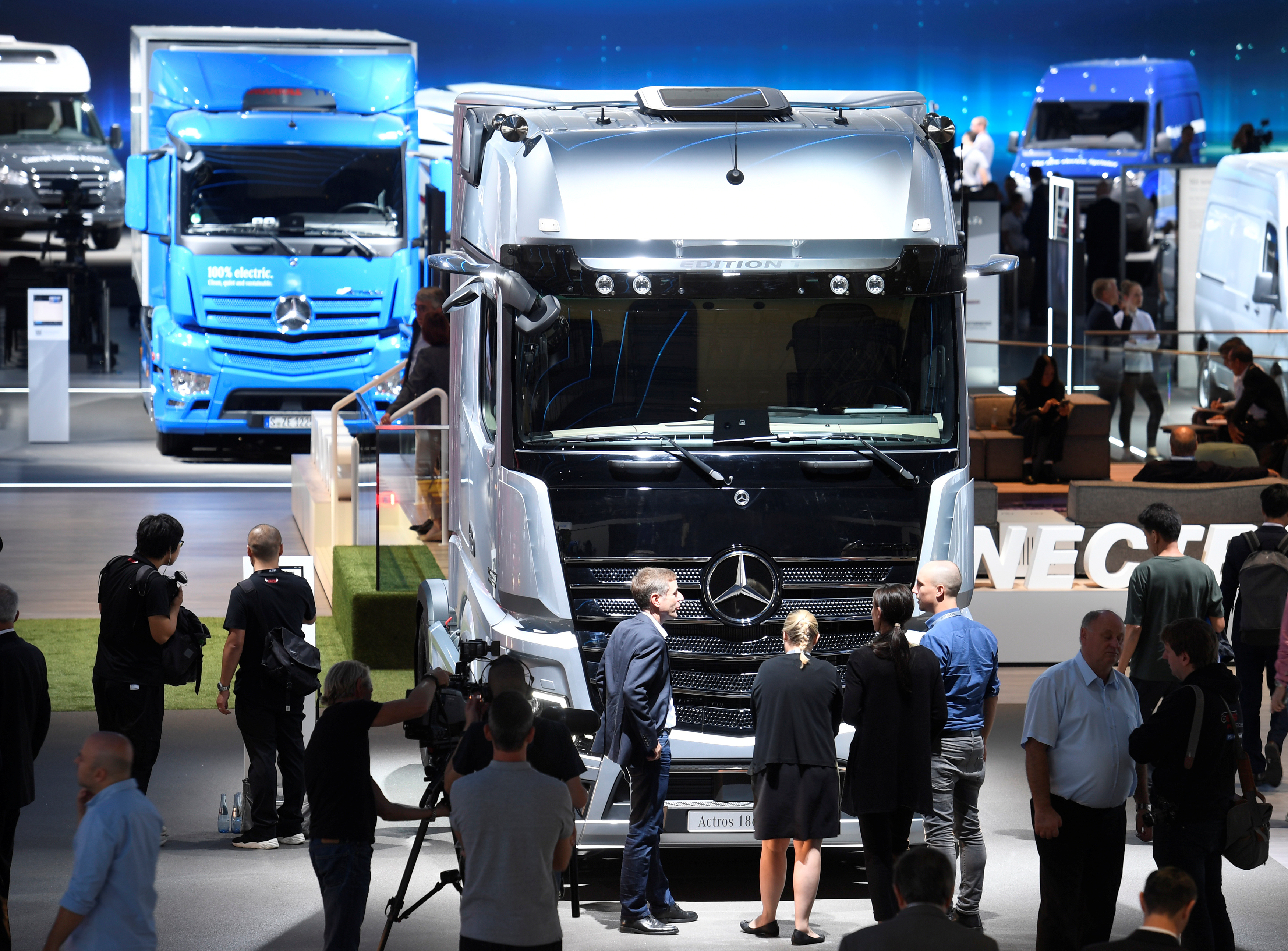 Visitors surround an Actros truck of German truck maker Mercedes-Benz at the IAA truck trade fair in Hanover
