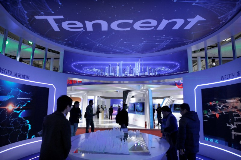 People visit Tencent's booth at the World 5G Exhibition in Beijing