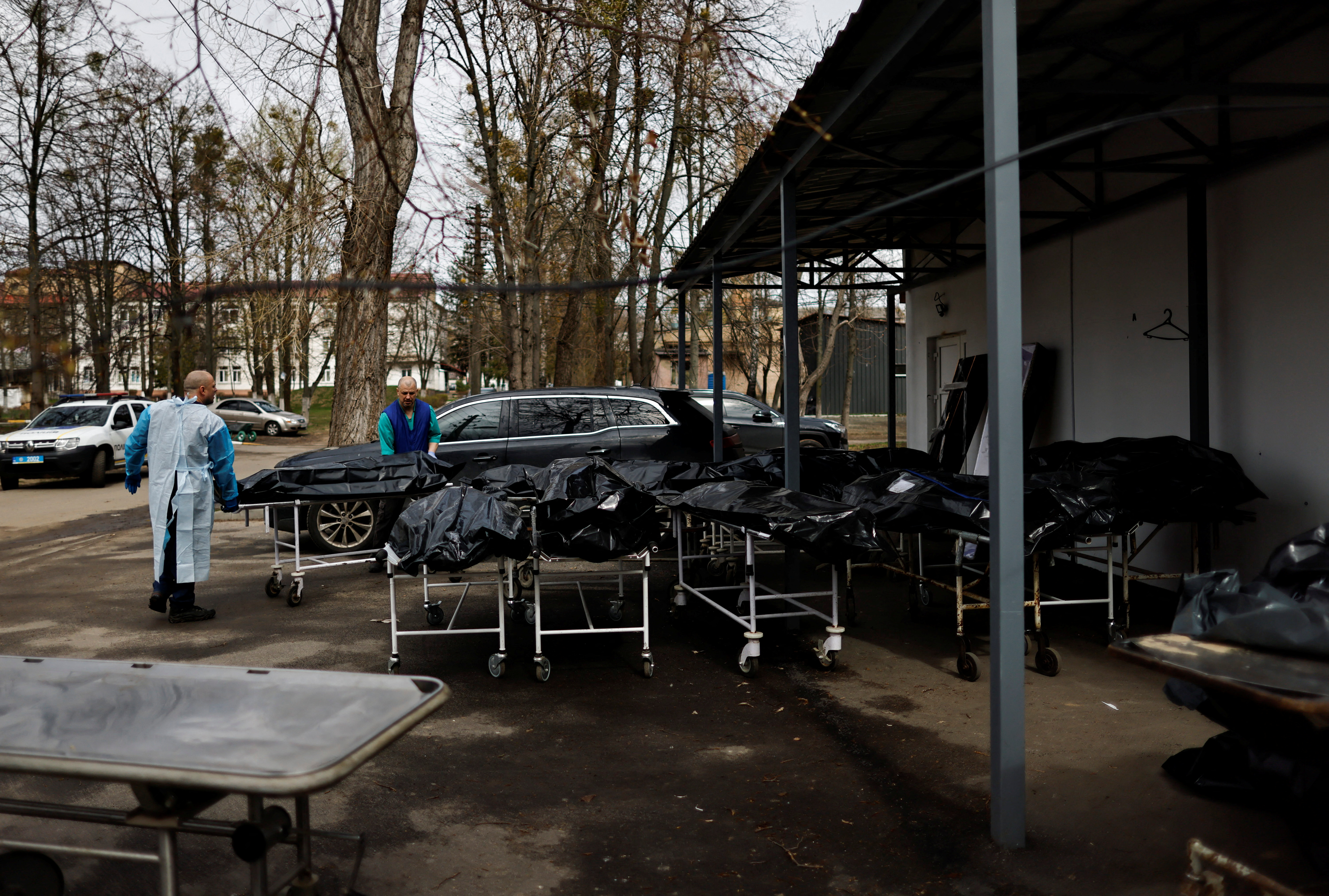 Bodies waiting to be identified by their families, amid Russia's invasion of Ukraine, are seen outside the morgue in Bucha