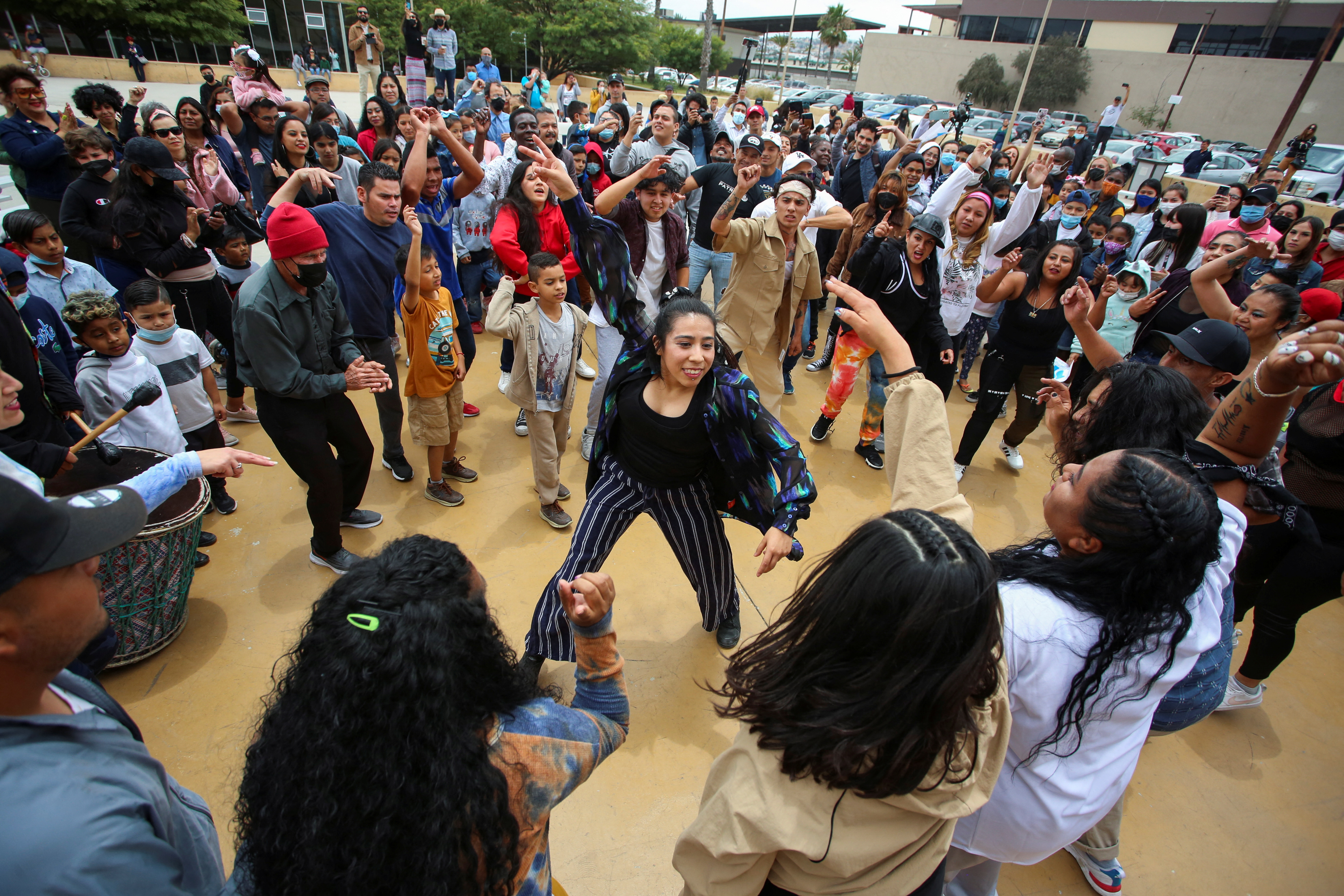 Migrants dance during an event named 
