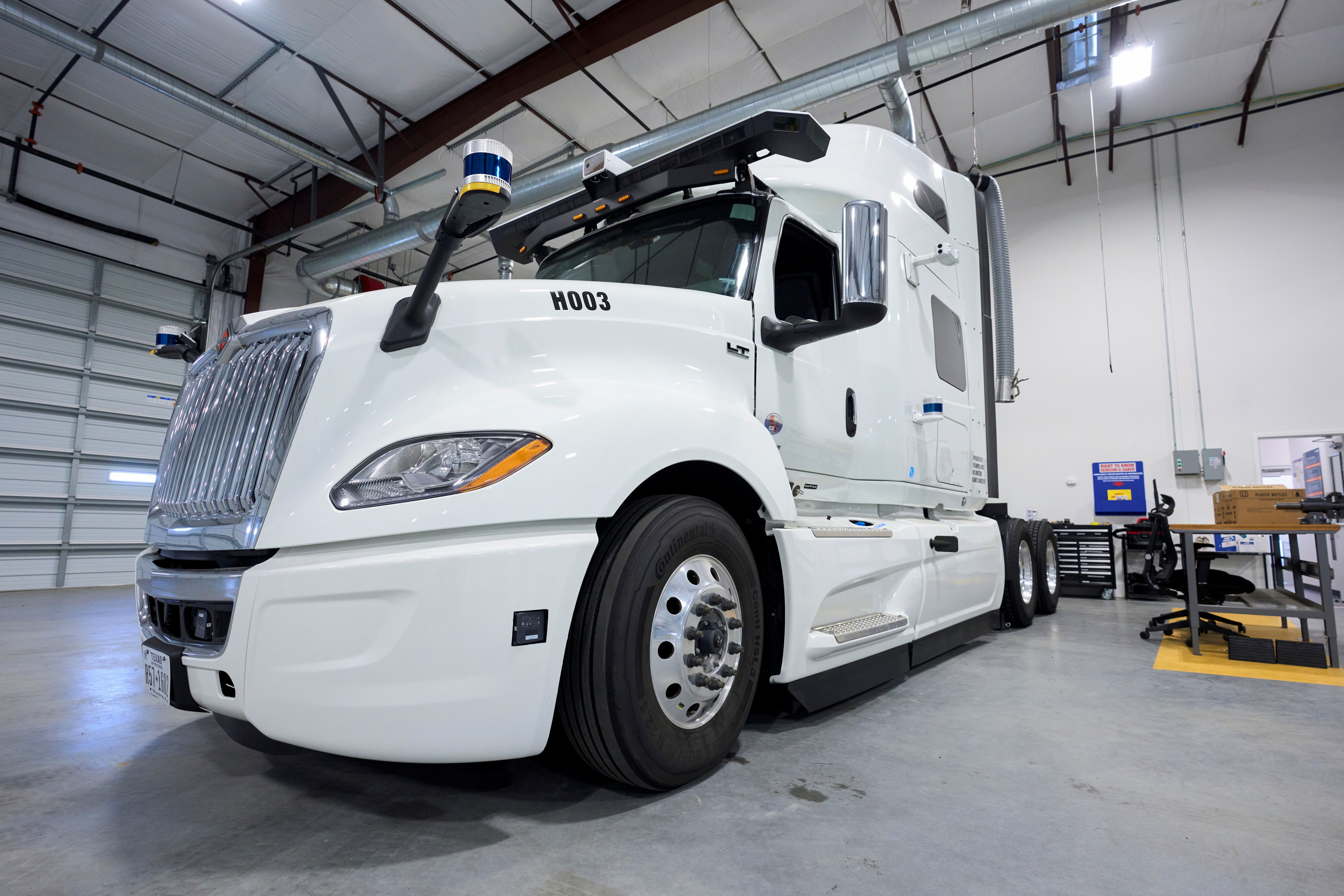 AV trucks are parked in a garage at AllianceTexas in Fort Worth