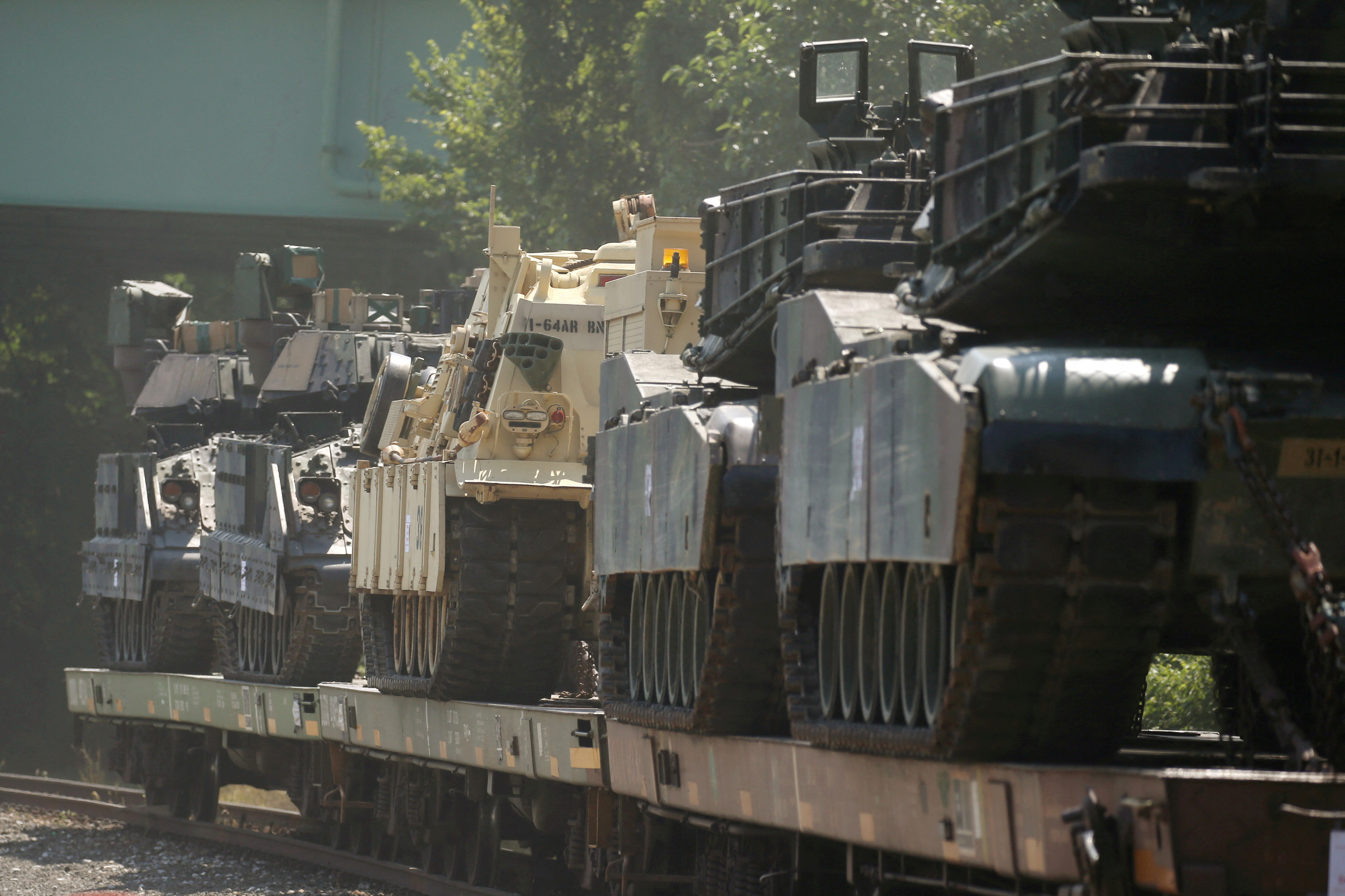 M1 Abrams tanks and armored vehicles sit in a rail yard in Southeast Washington