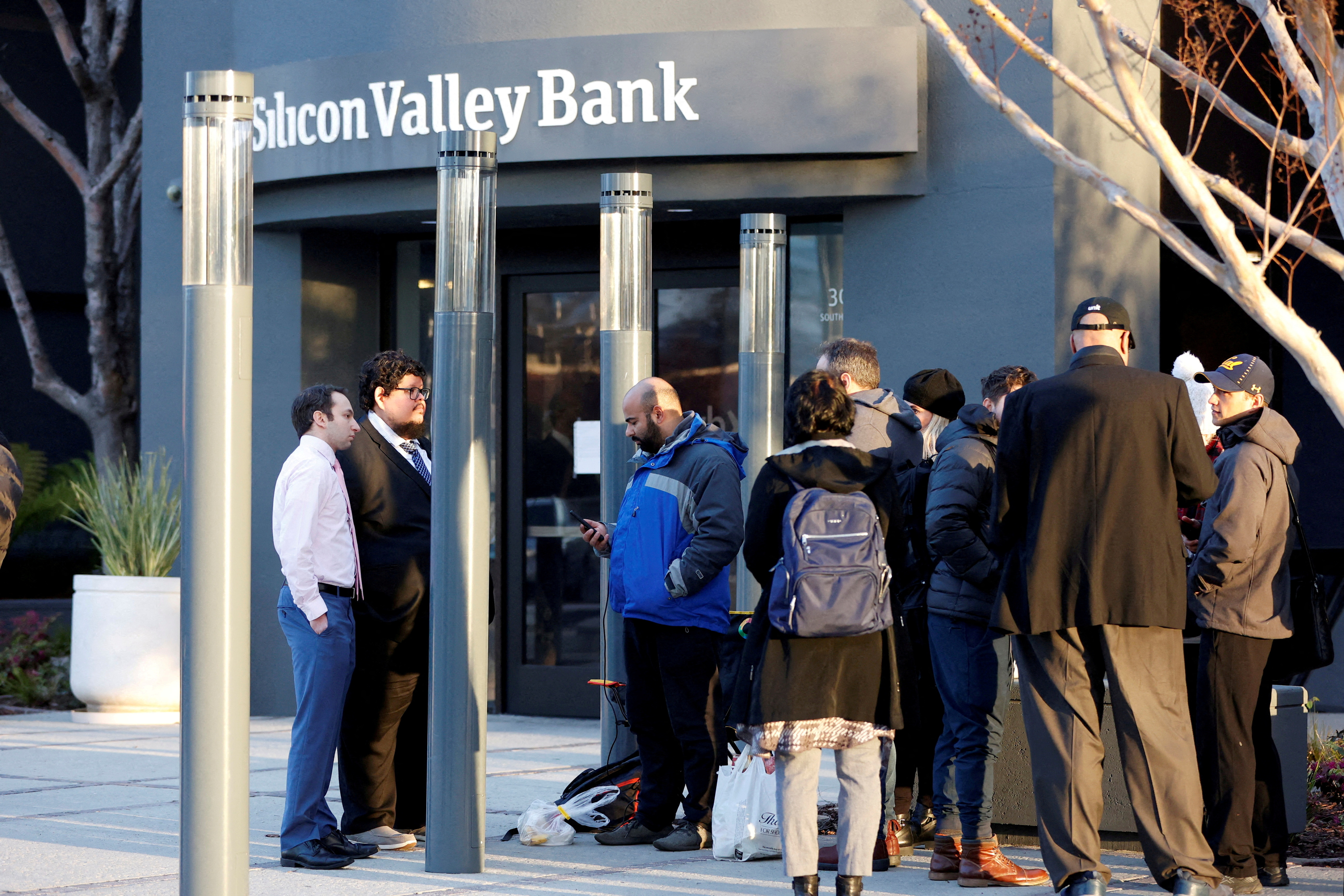 Customers stand outside the Silicon Valley Bank headquarters in Santa Clara