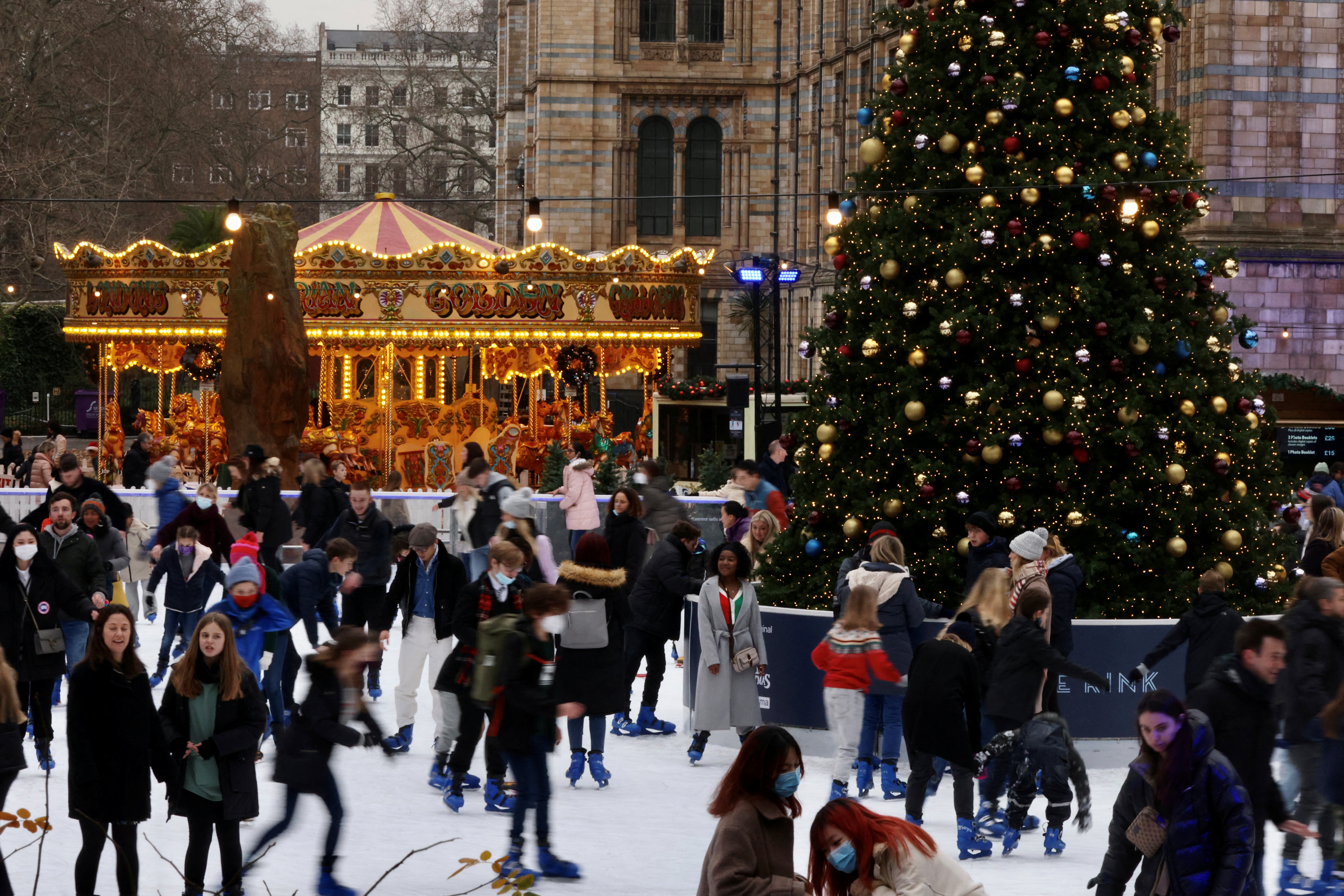 People ice skate around the Christmas tree at the Natural History Museum amid the coronavirus disease (COVID-19) outbreak, in London, Britain December 21, 2021. REUTERS/Kevin Coombs