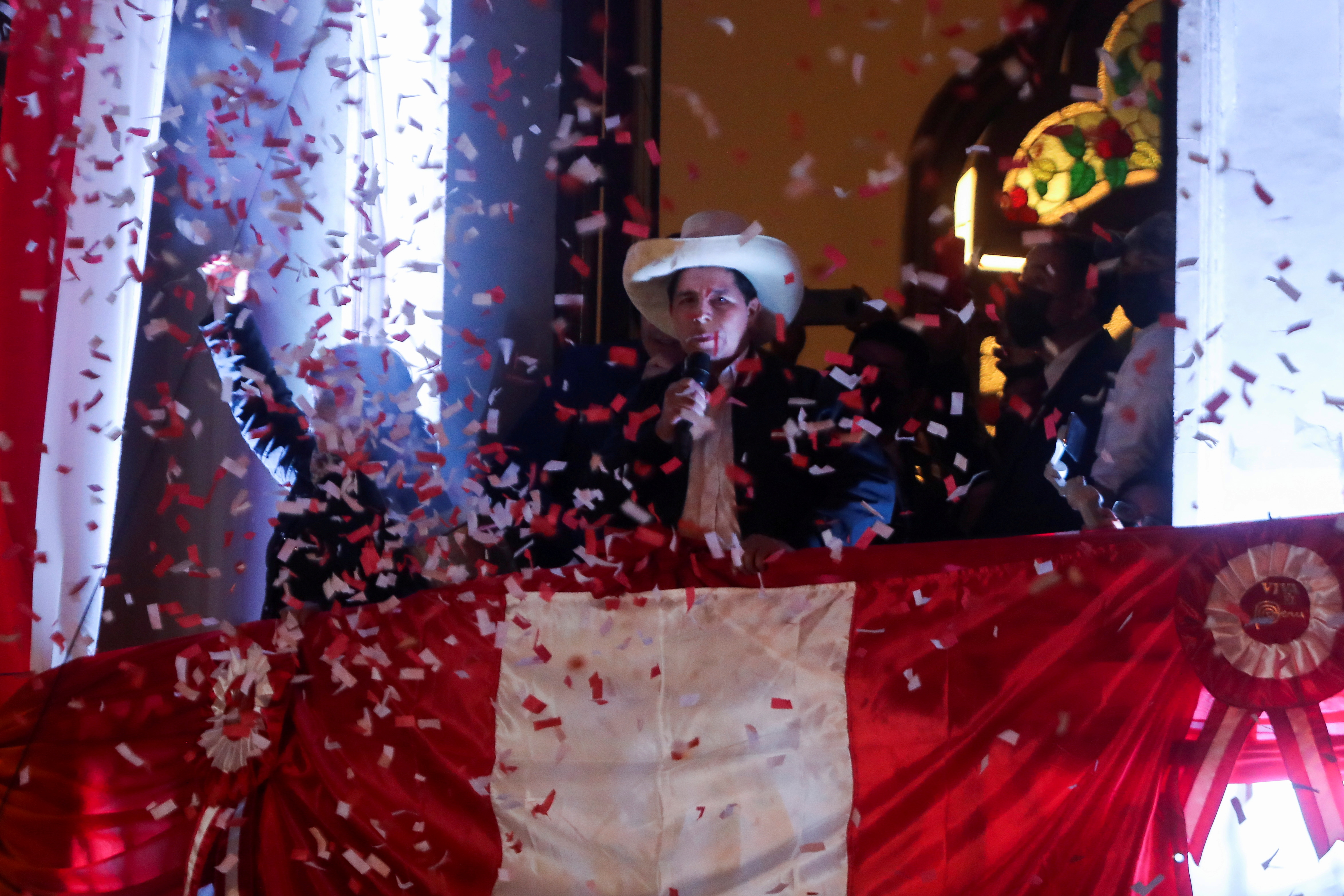 Leftist Pedro Castillo celebrates after Peru's electoral authority announced him as the winner of the presidential election, in Lima