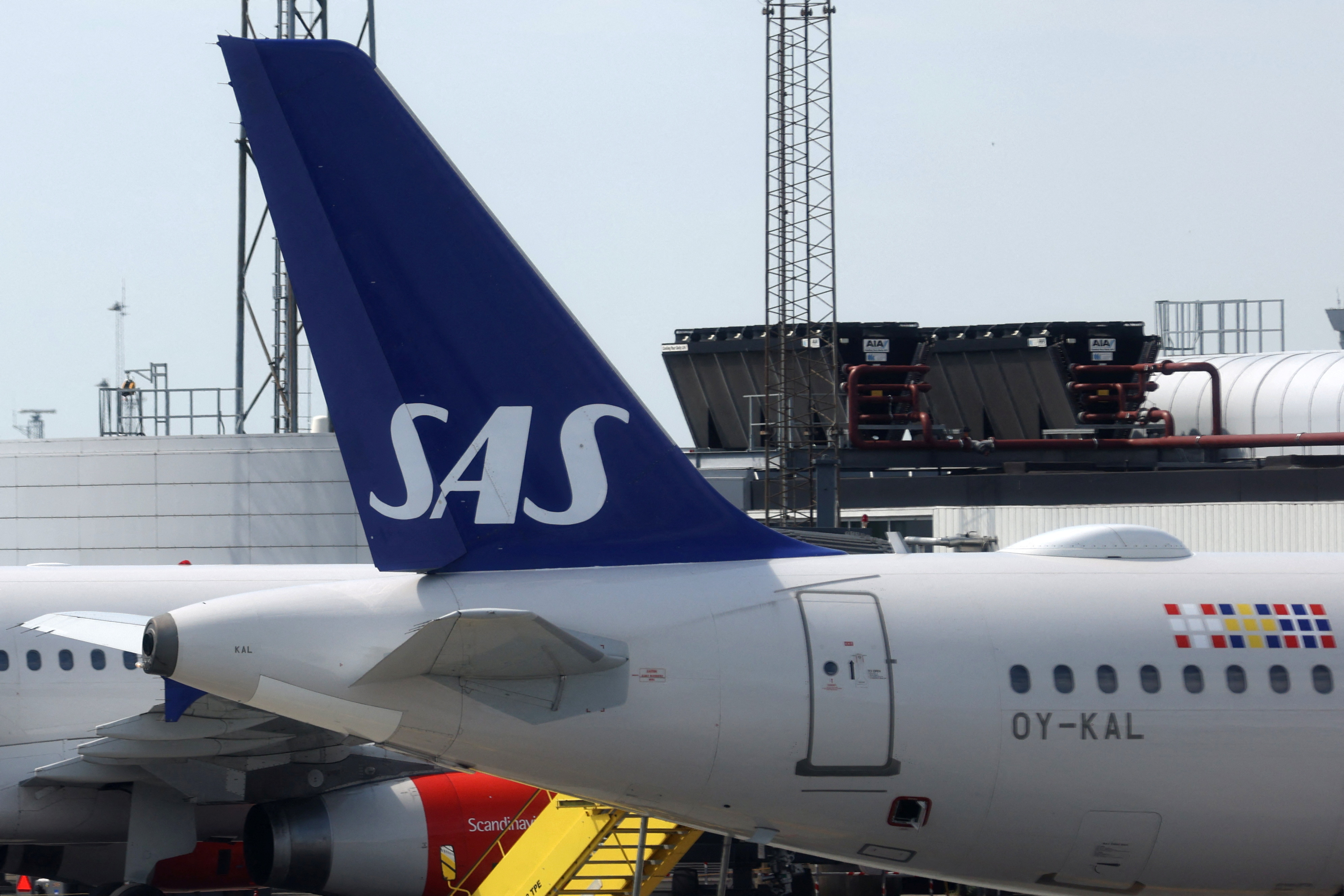 The tail fin of a Scandinavian Airlines (SAS) airplane parked on the tarmac at Copenhagen Airport Kastrup in Copenhagen
